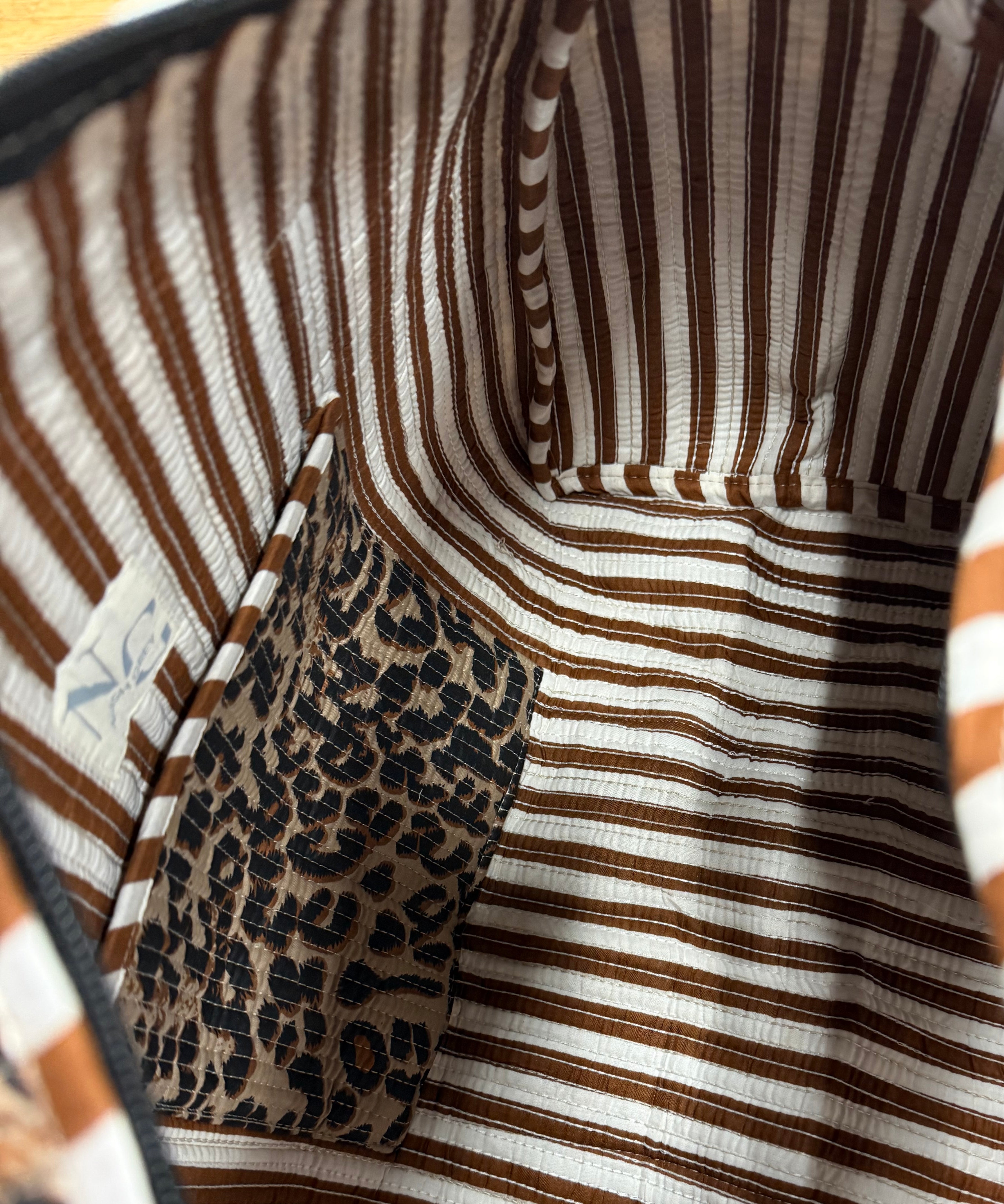 Close-up of a patterned fabric with leopard print and striped design.