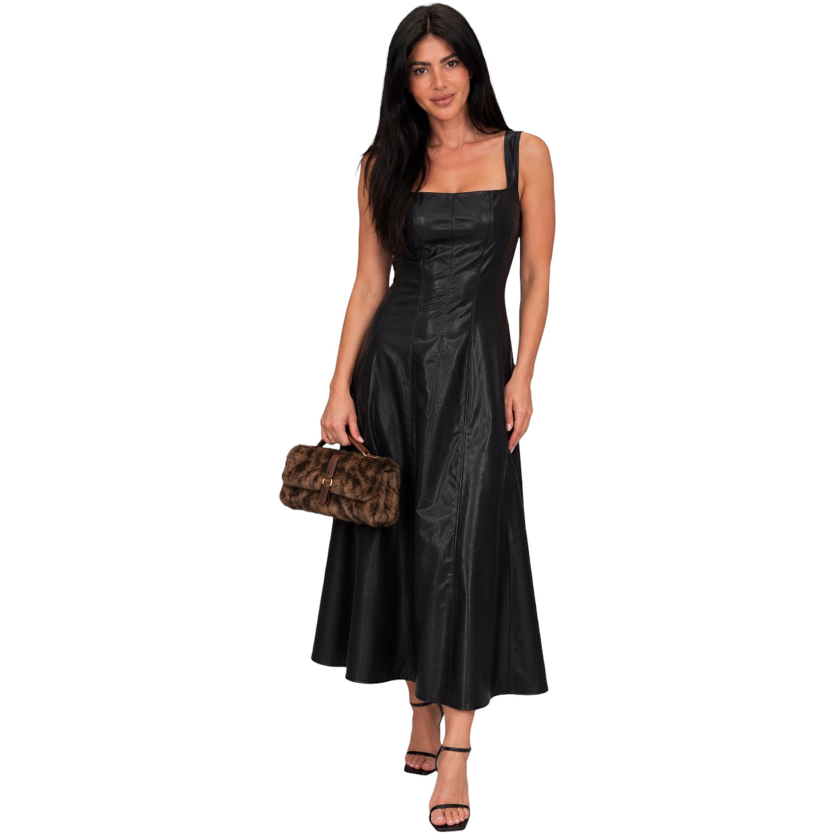A woman modeling a black sleeveless midi dress with a square neckline and a fitted, flared skirt, holding a brown textured clutch against a plain white background.