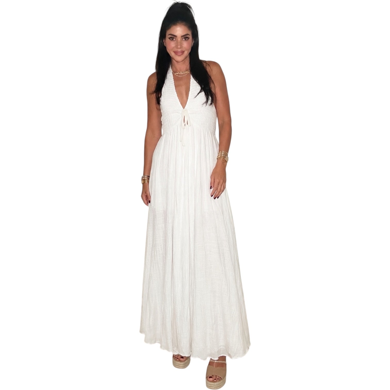Woman wearing a white halter neck dress on a white background