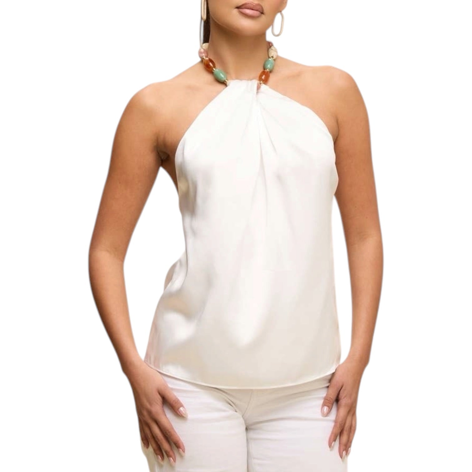 Woman wearing a white halter top and white pants on a white background