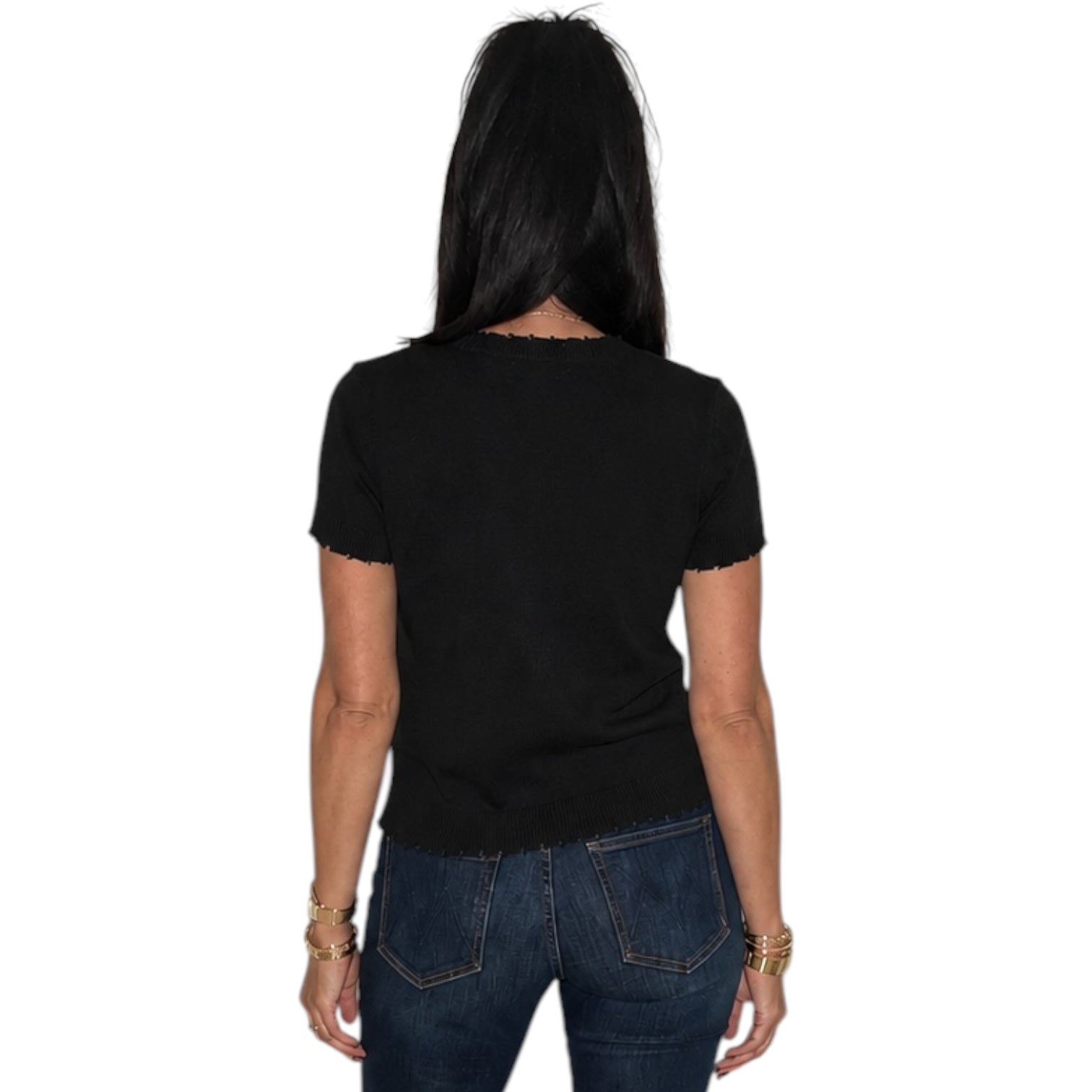A woman viewed from the back wearing a black short-sleeve t-shirt and dark blue jeans, set against a plain white background.