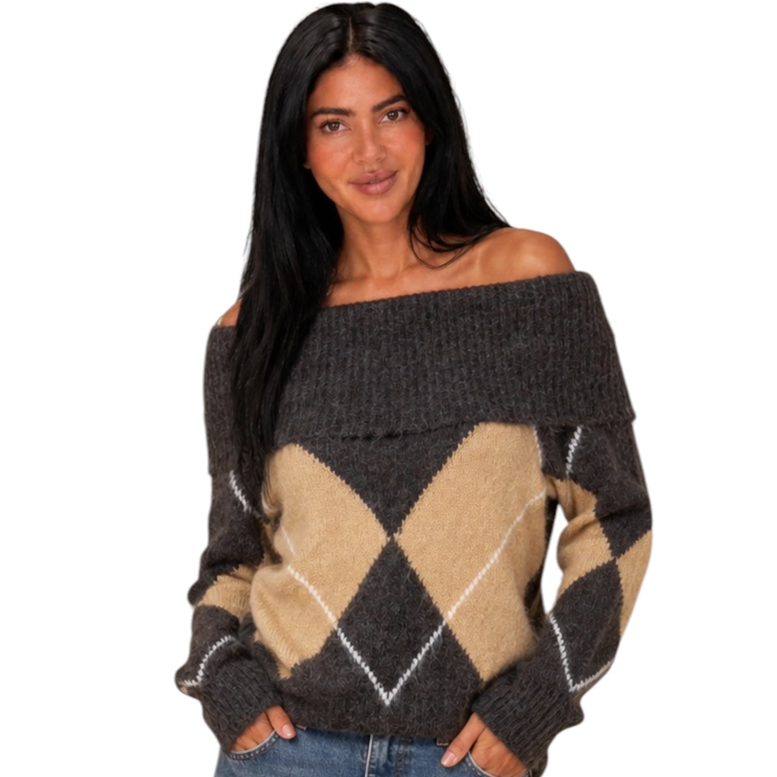 A woman modeling a dark brown off-the-shoulder knit sweater with a tan and white argyle pattern on the front, paired with blue jeans against a plain white background.