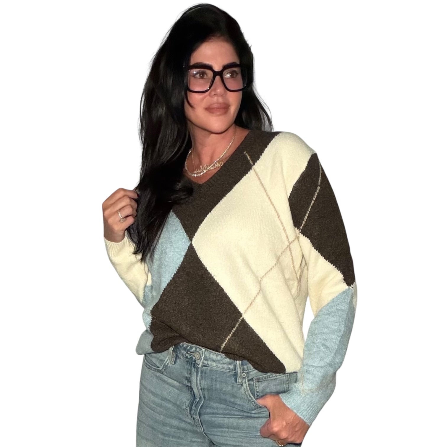 Woman wearing a patterned sweater and jeans on a white background