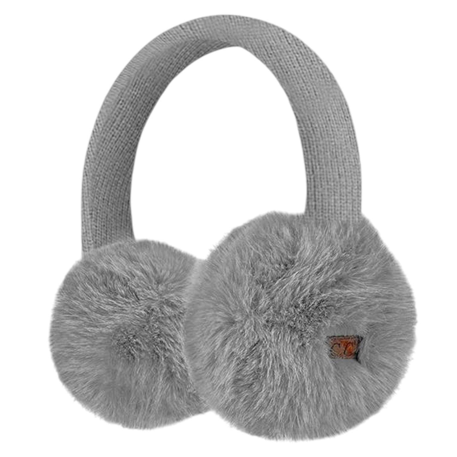 Light gray knit earmuffs with fluffy faux-fur ear cups and a small orange brand tag on the right cup, shown on a plain white background.