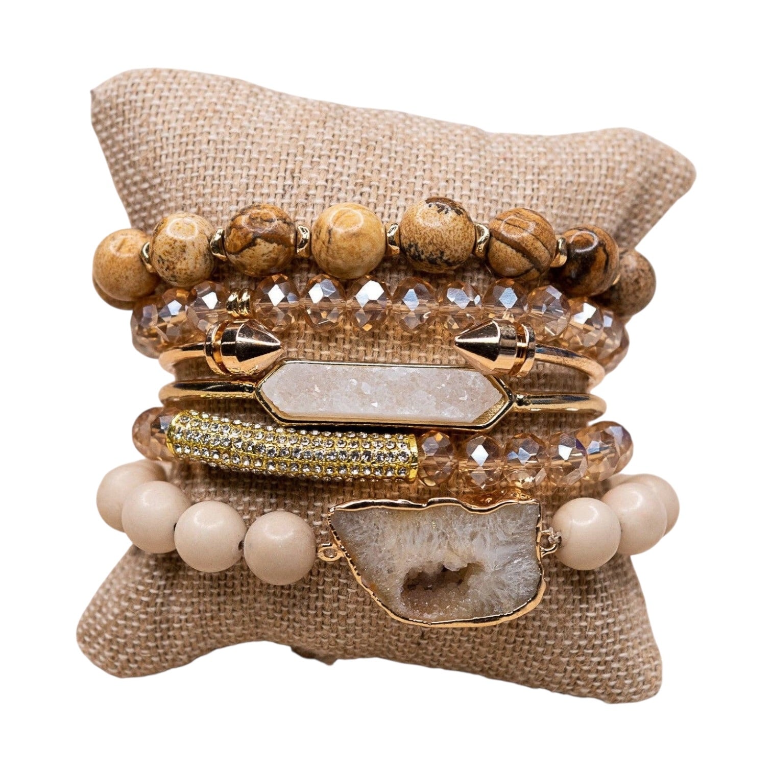 Set of beaded and crystal bracelets on a textured surface