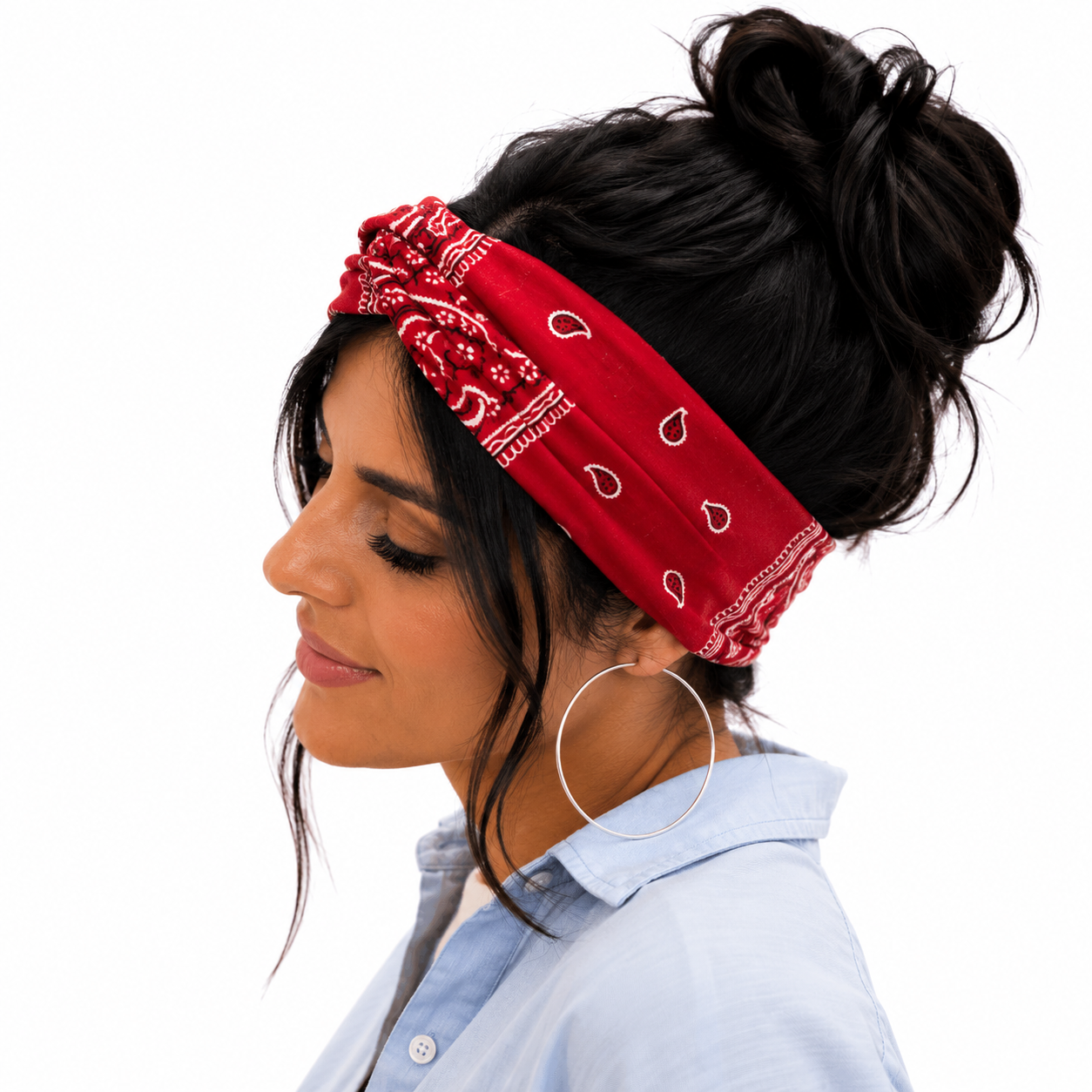Woman wearing a red bandana headband with white patterns on a white background