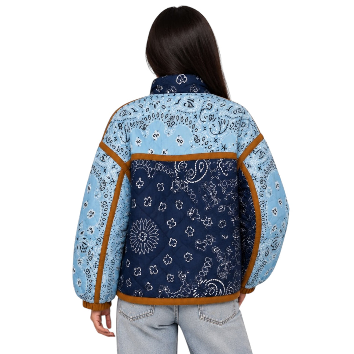 A woman shown from the back wearing a light blue and navy bandana-patterned jacket with brown trim, paired with light-wash jeans, against a plain white background.