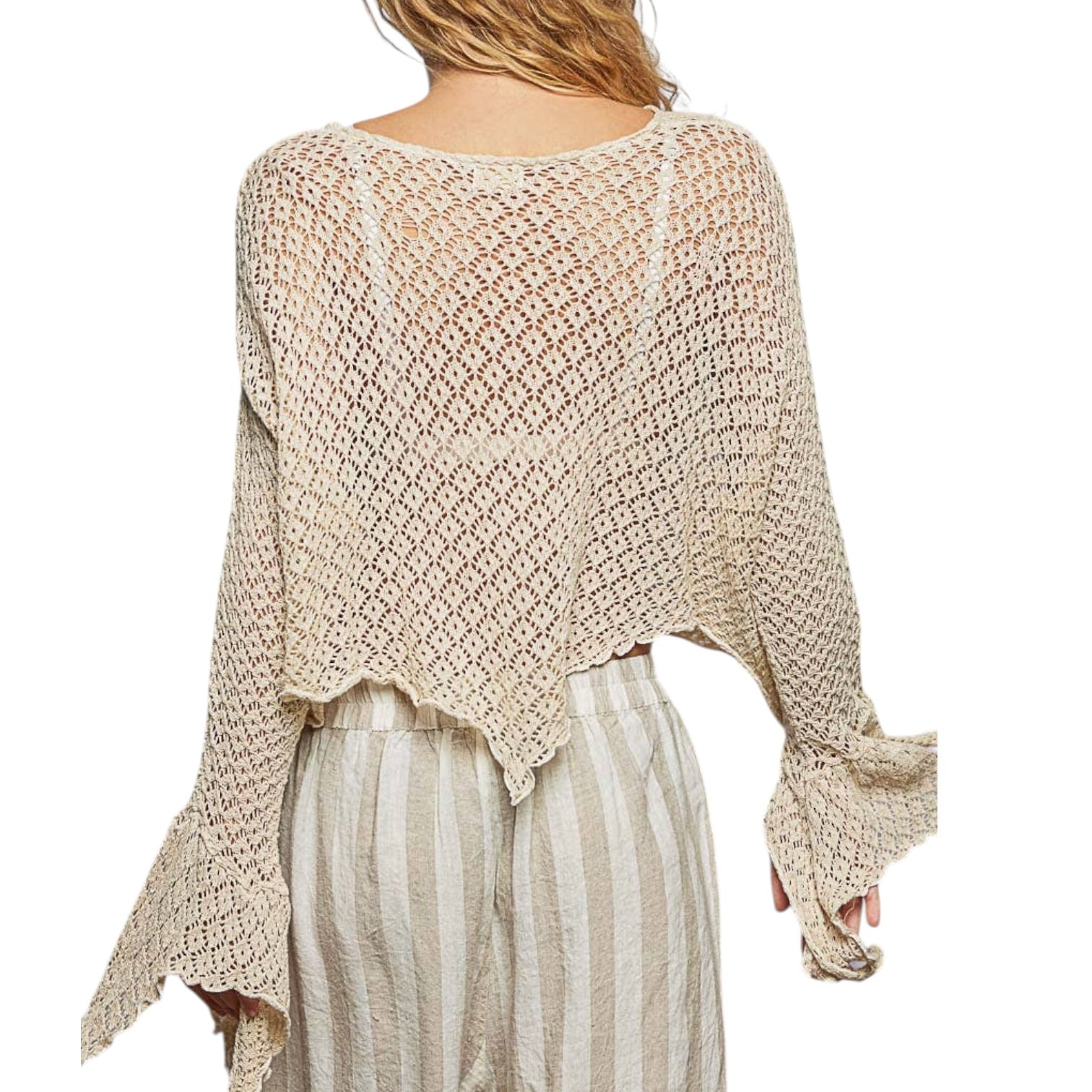 Beige crochet top worn by a person on a white background