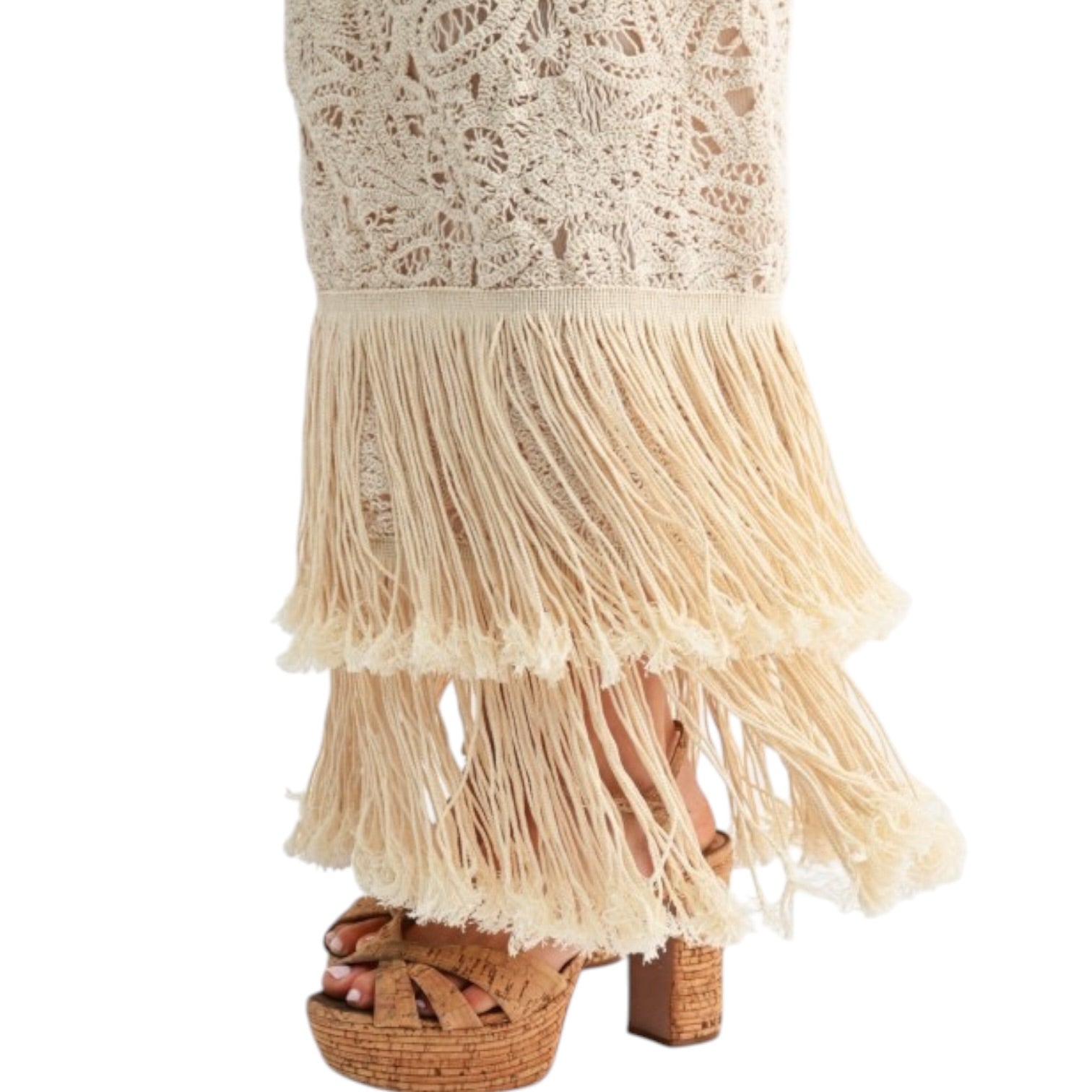 Beige lace dress with fringe hem on a white background