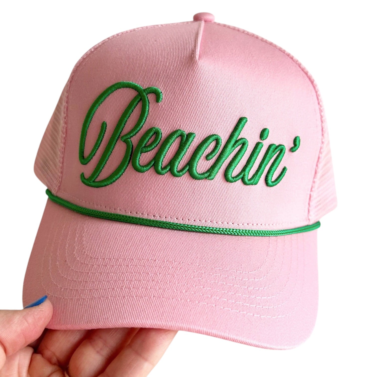 Pink cap with green 'Beachin'' text on a white background