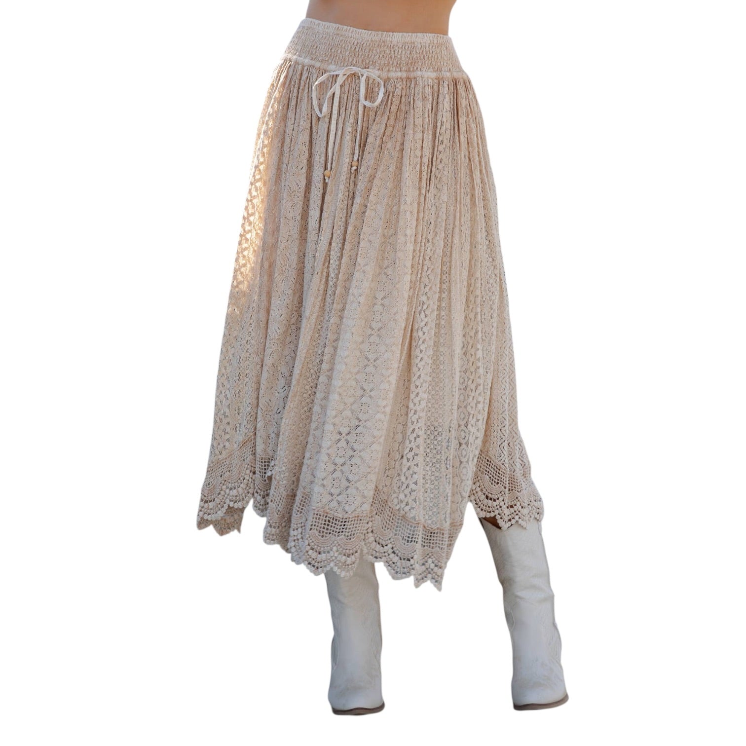 Beige lace skirt with white boots on a white background