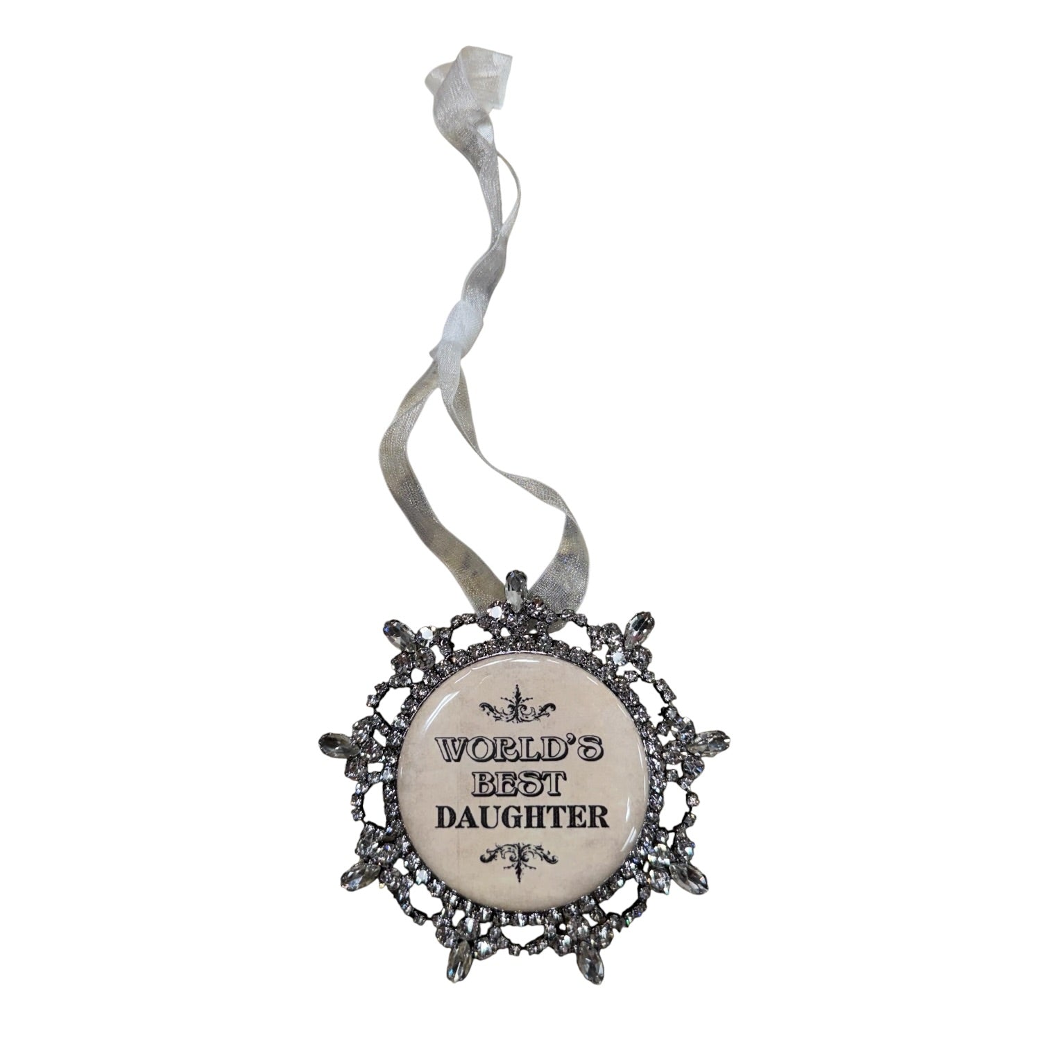 A decorative hanging ornament with a round cream center and ornate silver filigree border, printed with the phrase 'WORLD'S BEST DAUGHTER' in black lettering, suspended from a sheer silver ribbon on a white background.