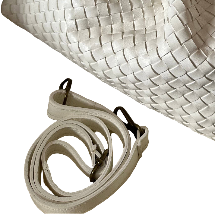 White woven bag with matching strap on a white background