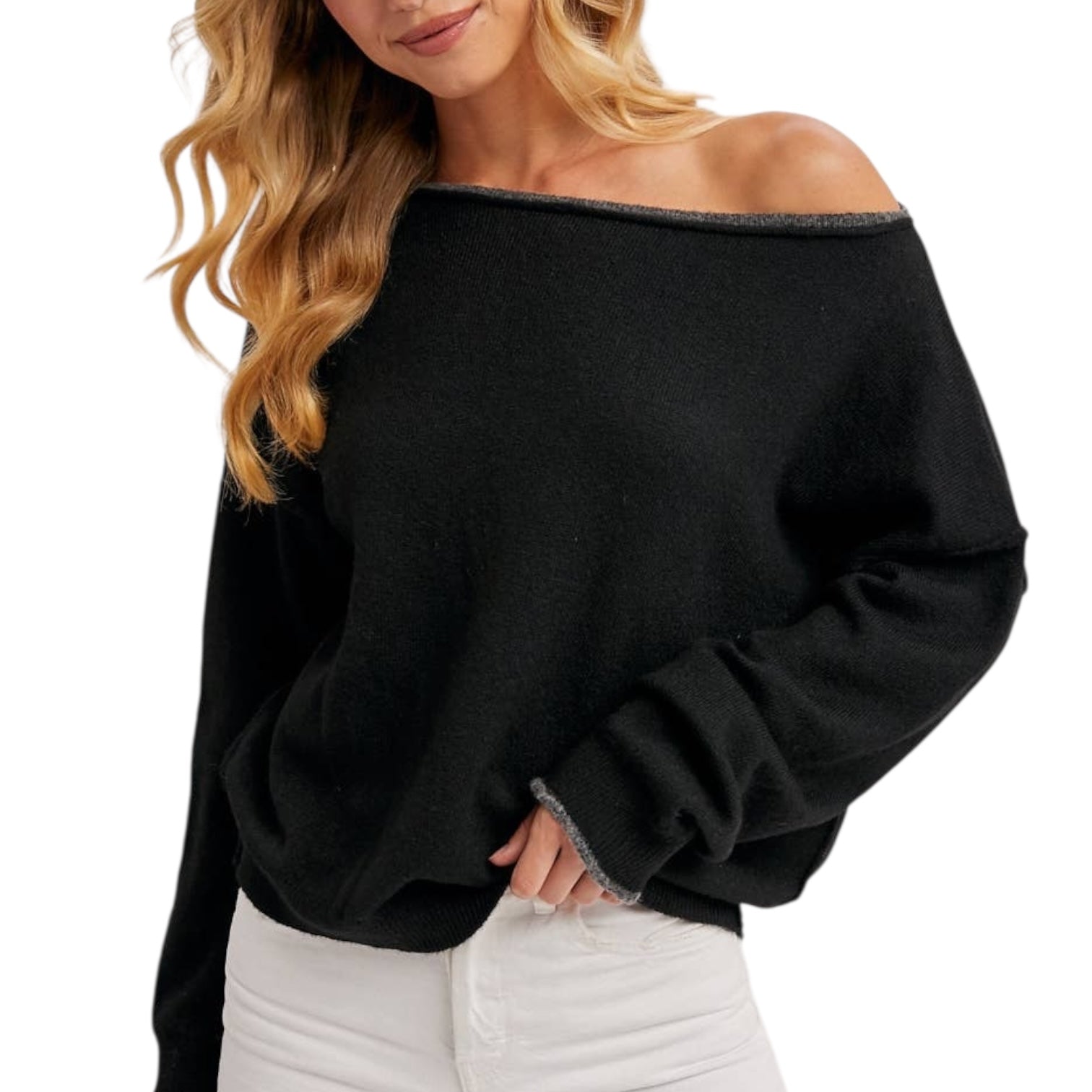 Black off-shoulder sweater worn by a person on a white background