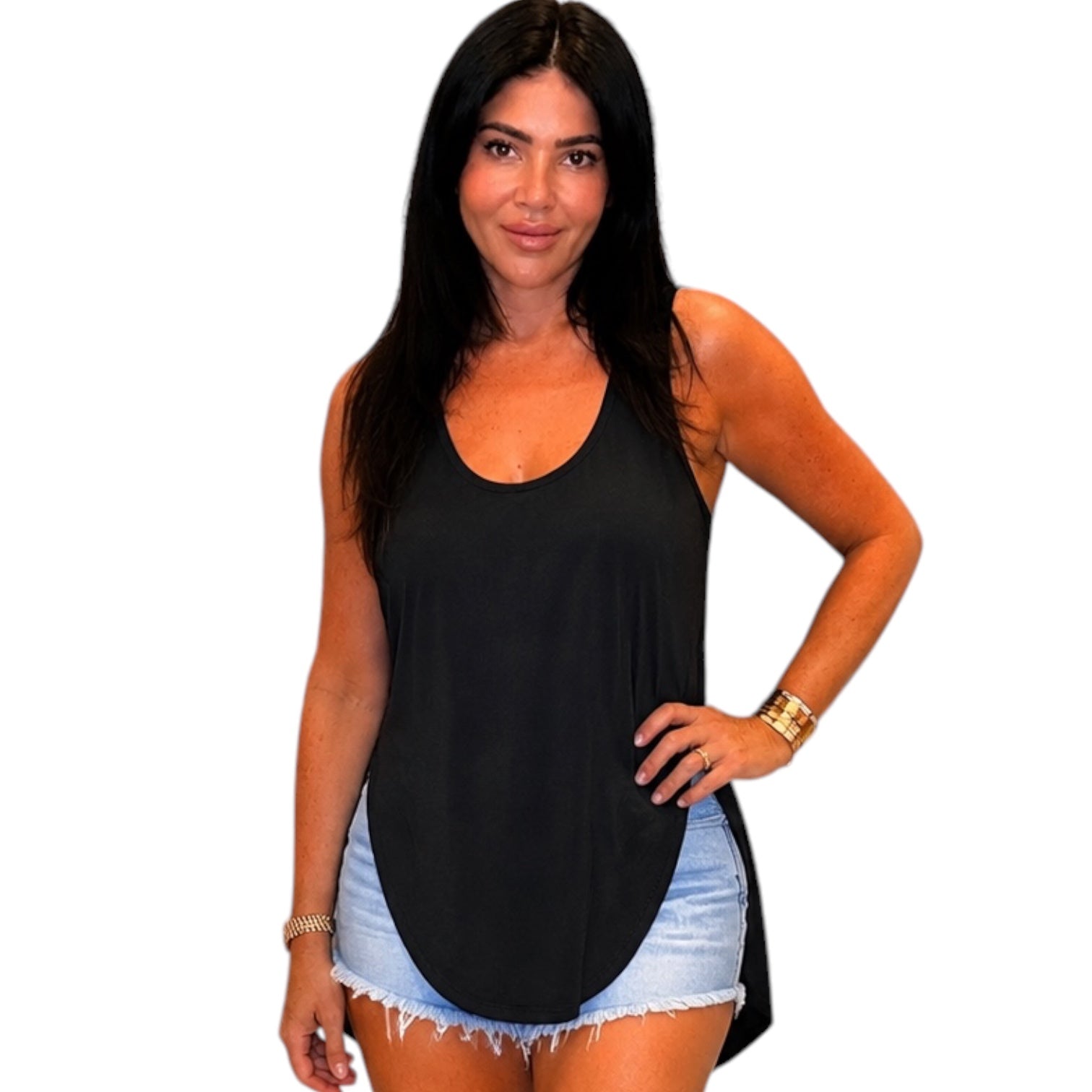 Woman wearing a black tank top and denim shorts on a white background