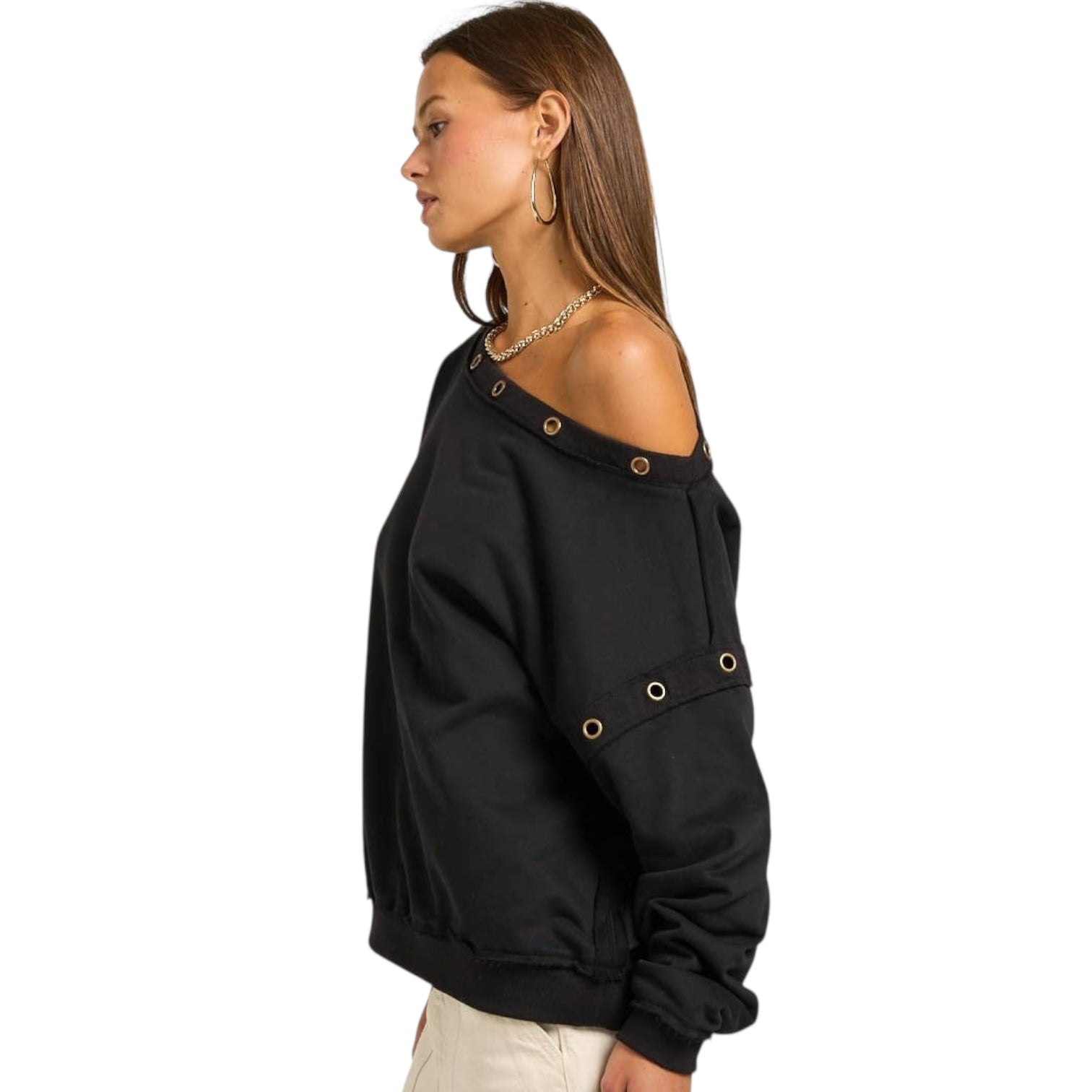 Woman wearing a black off-shoulder sweatshirt on a white background