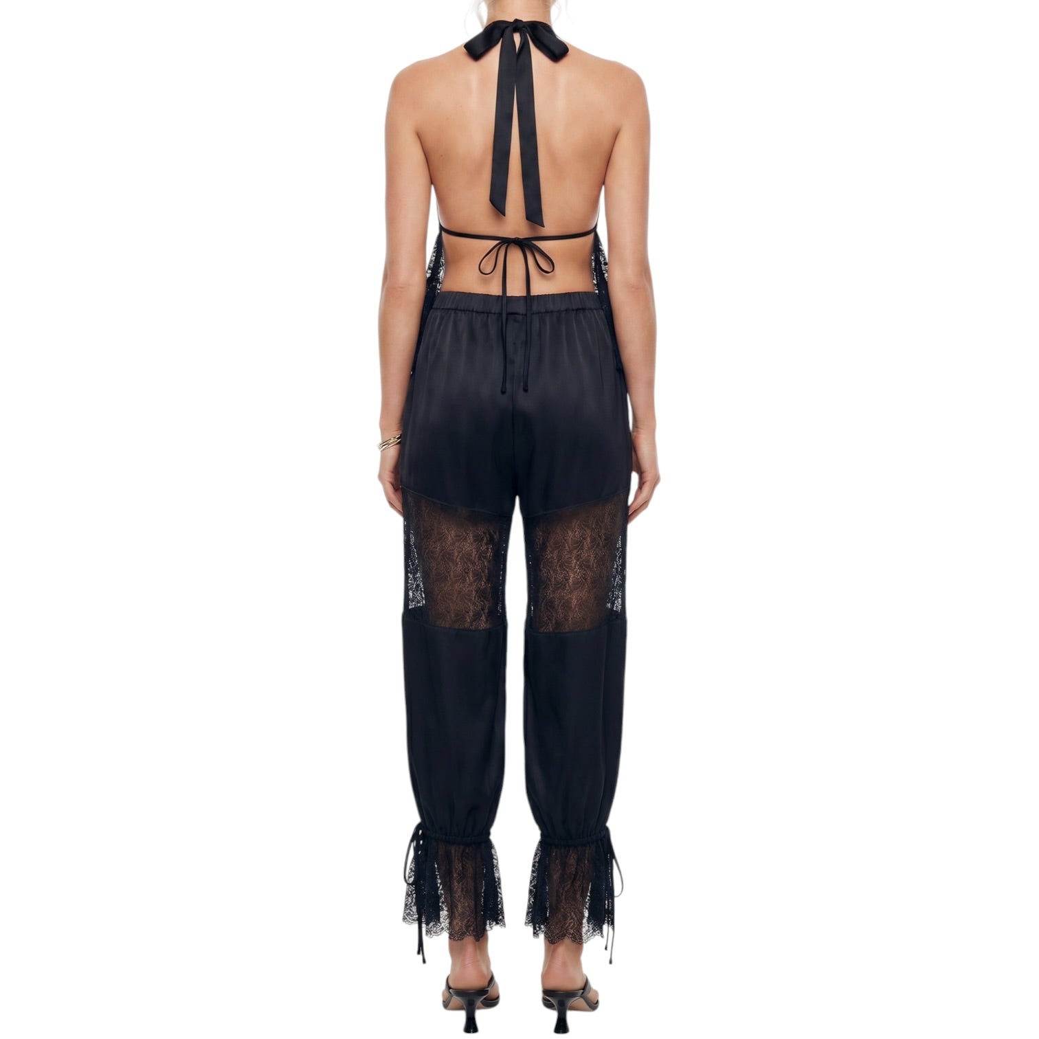 Black lace outfit with open back on a white background