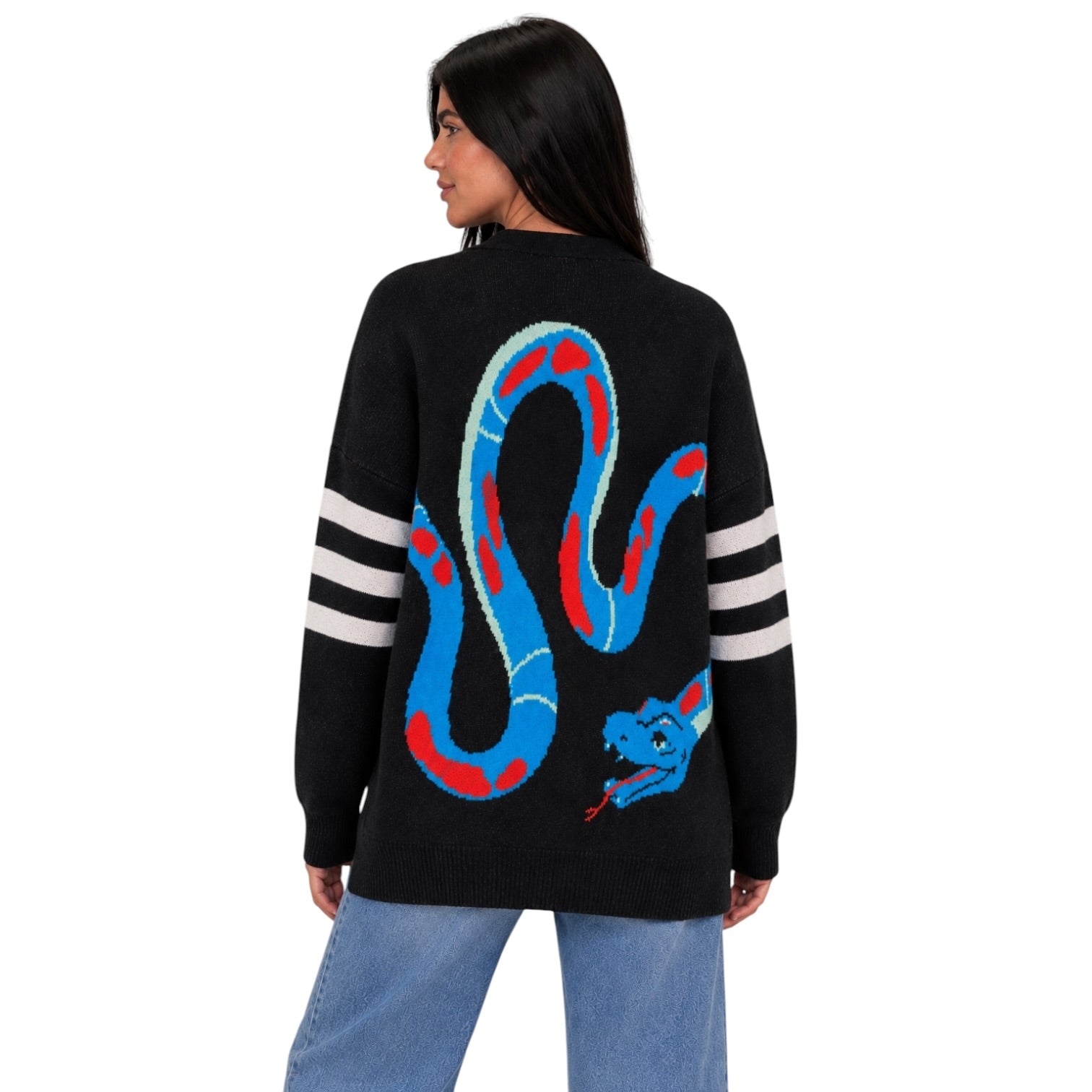 A woman shown from the back wearing a black knit sweater with a large blue and red snake graphic across the back and white stripes on the sleeves, paired with light blue jeans against a plain white background.