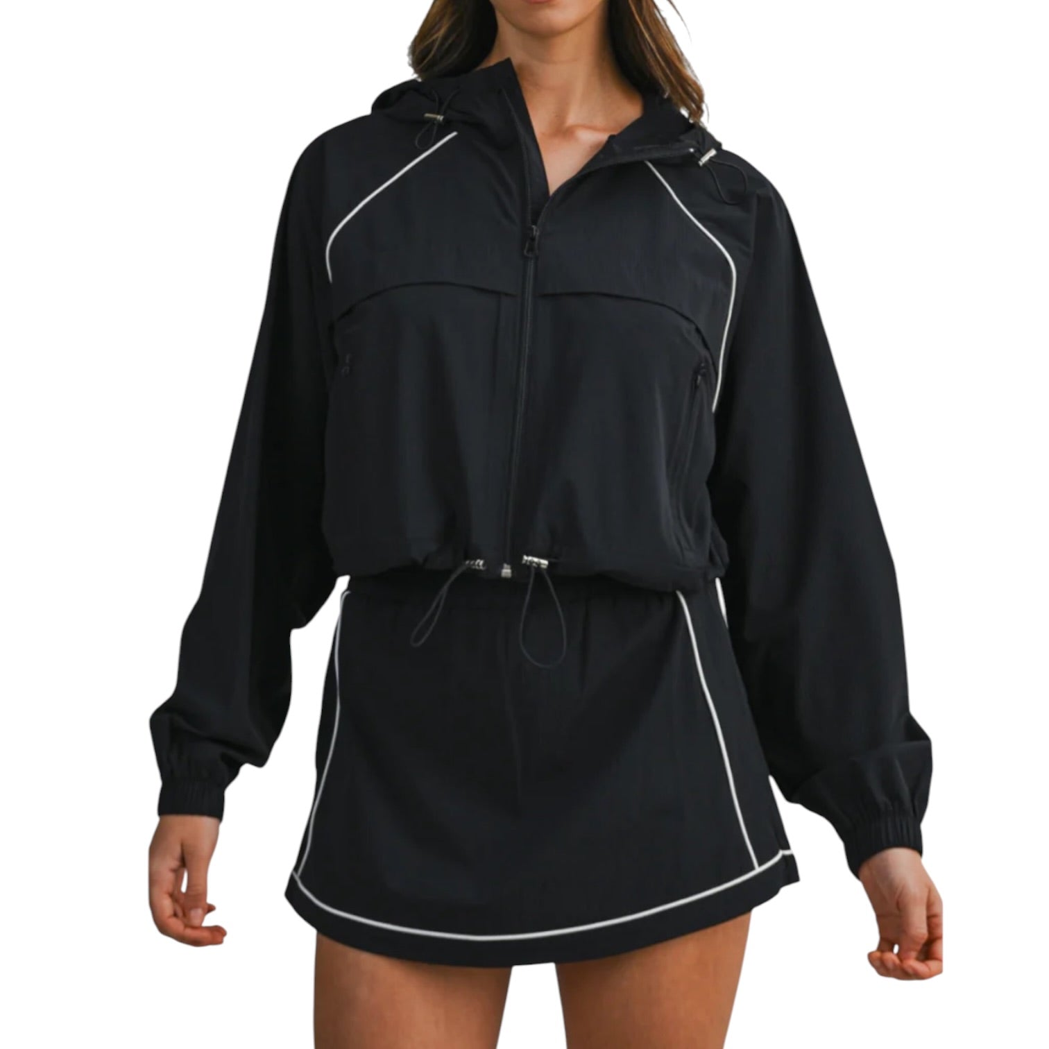 Black jacket with white accents worn by a person on a white background