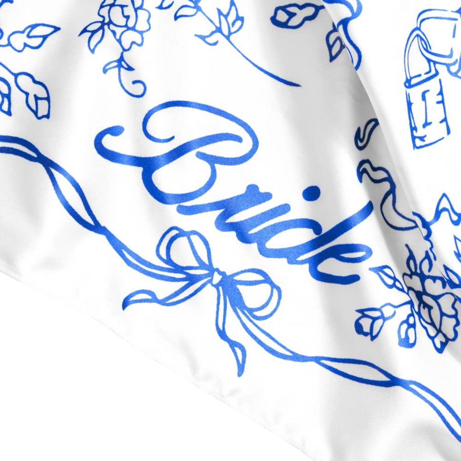 White fabric with blue floral patterns and the word 'Bride' printed on it.