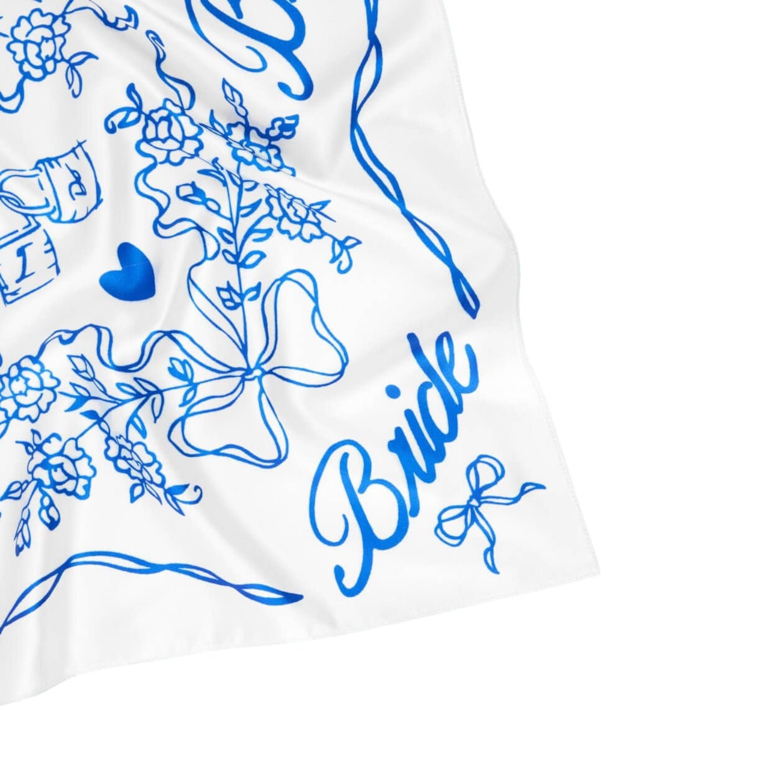 White fabric with blue floral and ribbon patterns and the word 'Bride' printed on it.