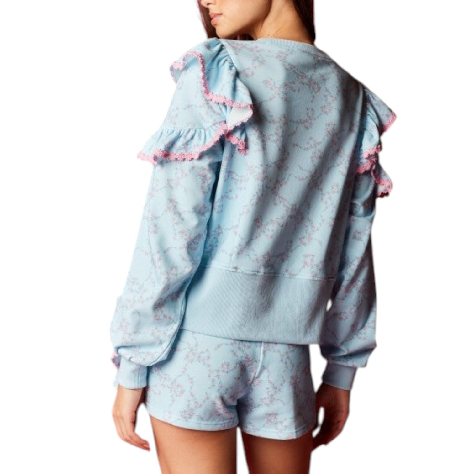 Light blue lounge set with ruffled details on a white background