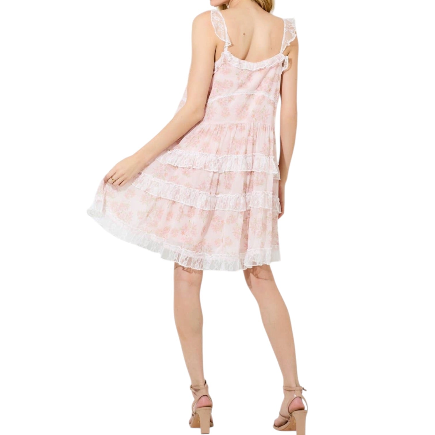 woman wearing pink floral tiered lace mini dress with white background