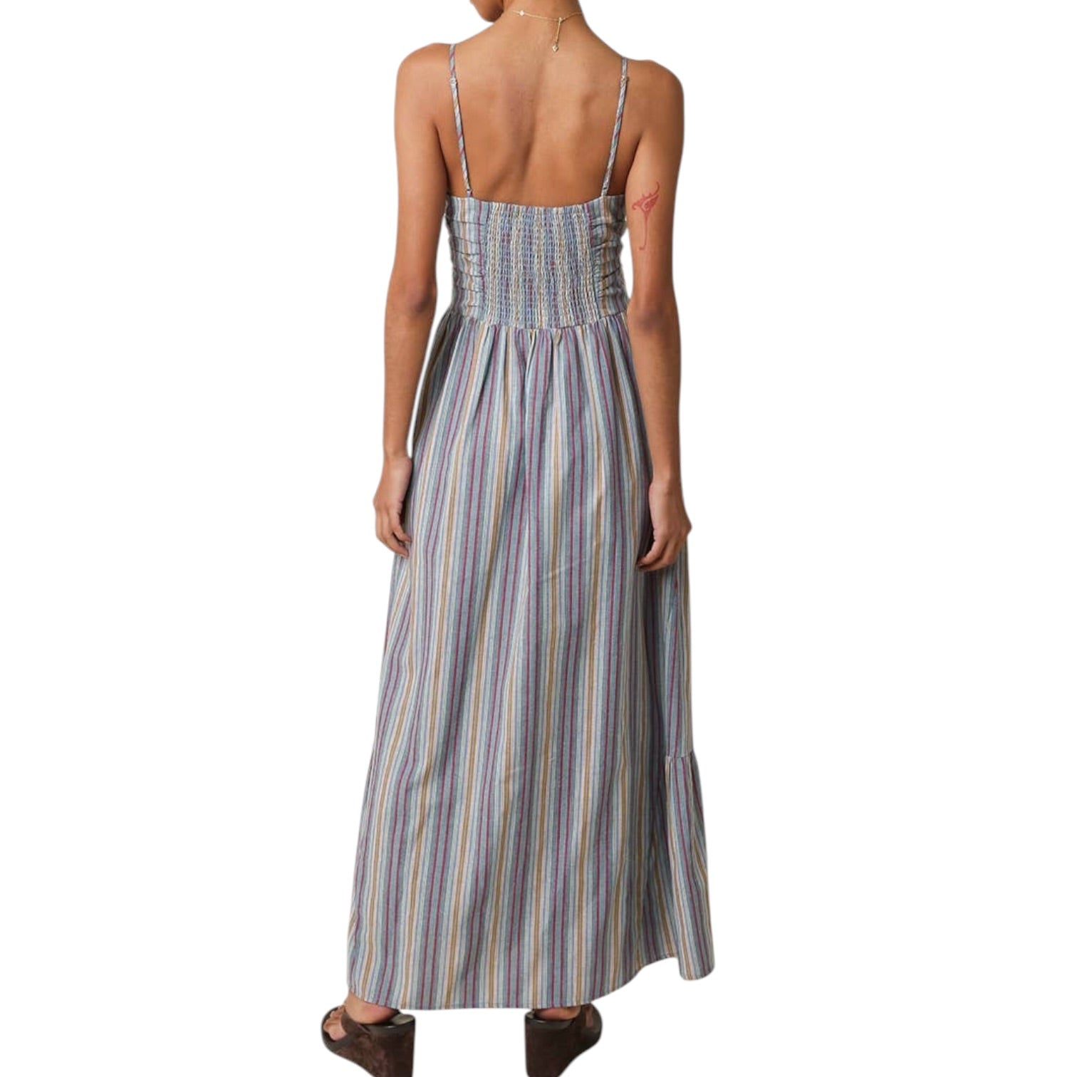Woman wearing a long striped dress on a white background