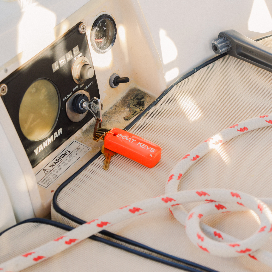 Close-up of a Yamaha outboard motor with a rope on a boat deck.