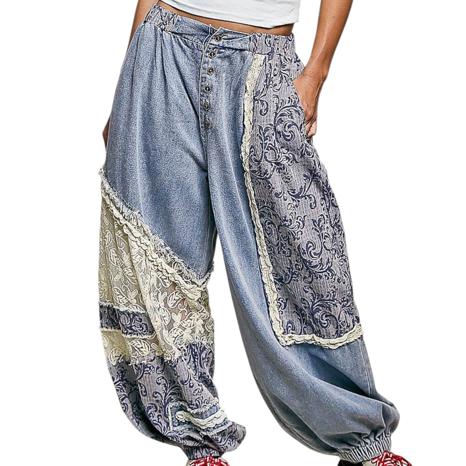 Light blue patchwork pants with lace details on a white background