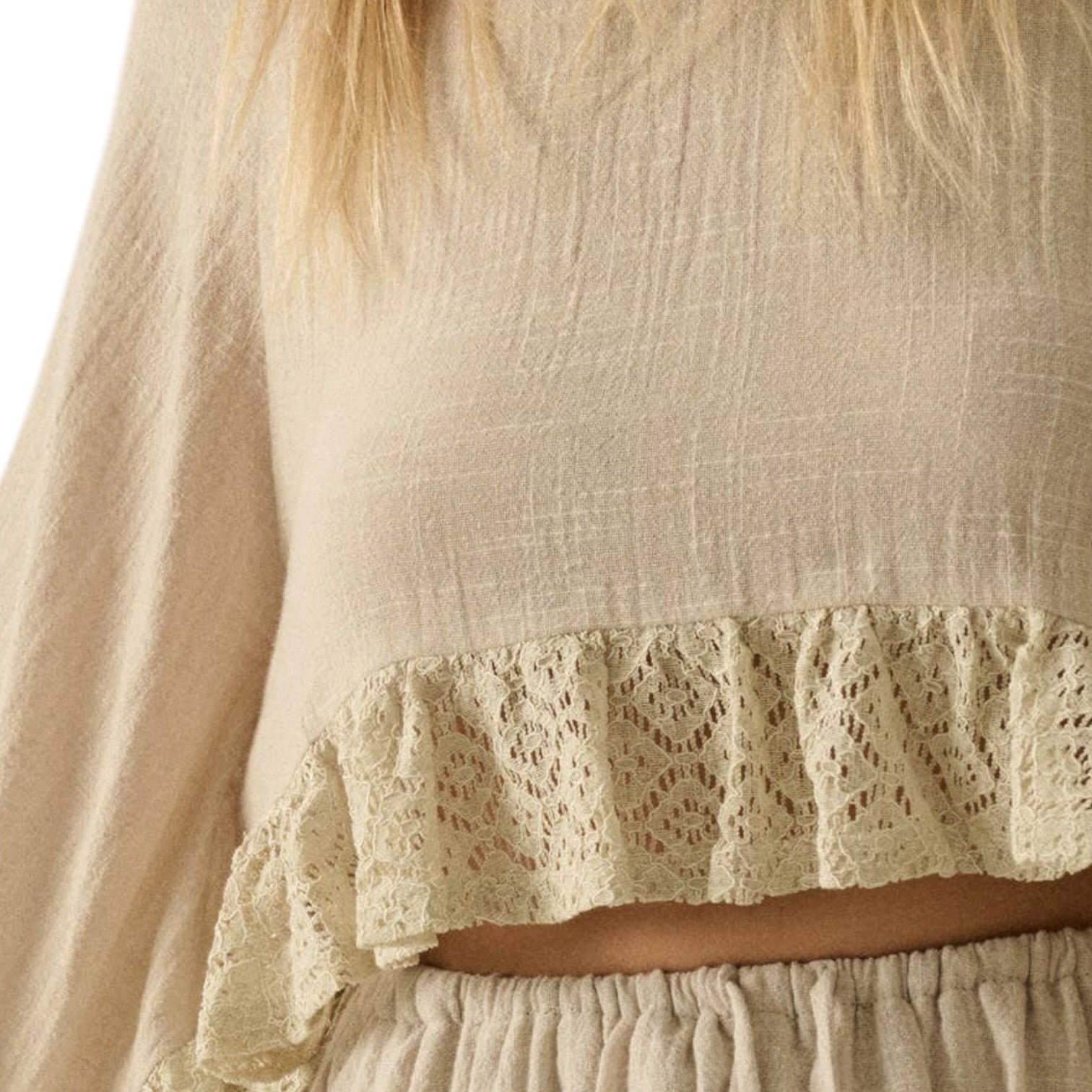 Beige dress with lace detailing on a neutral background