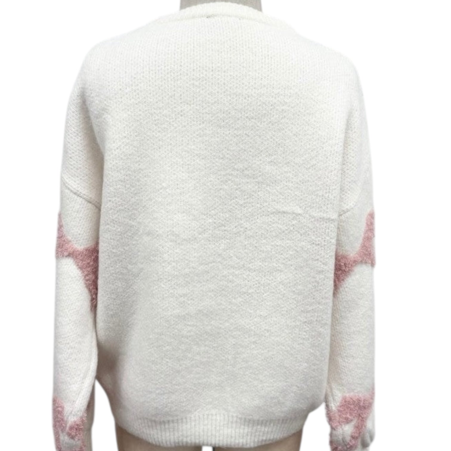 White sweater with pink star patterns on a white background