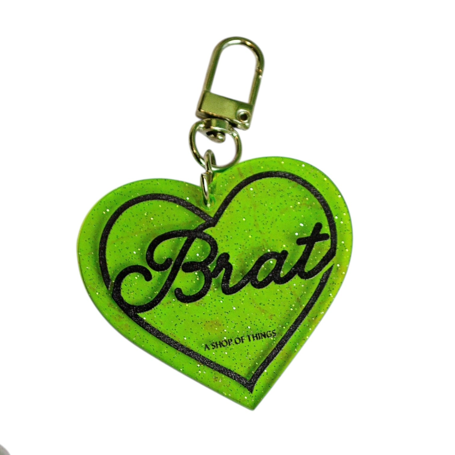 Green heart-shaped keychain with 'Brat' text on a white background