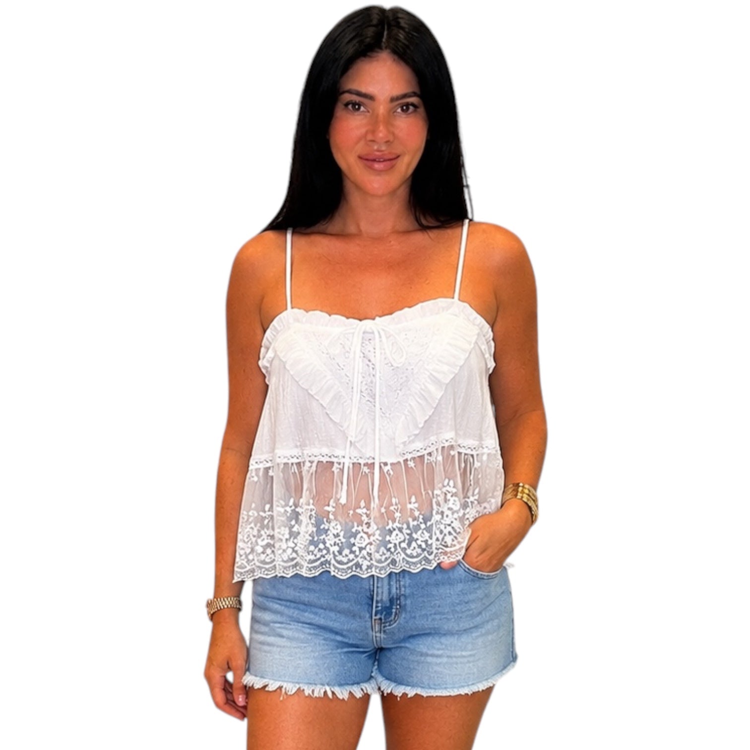 Woman wearing a white lace top and denim shorts on a white background