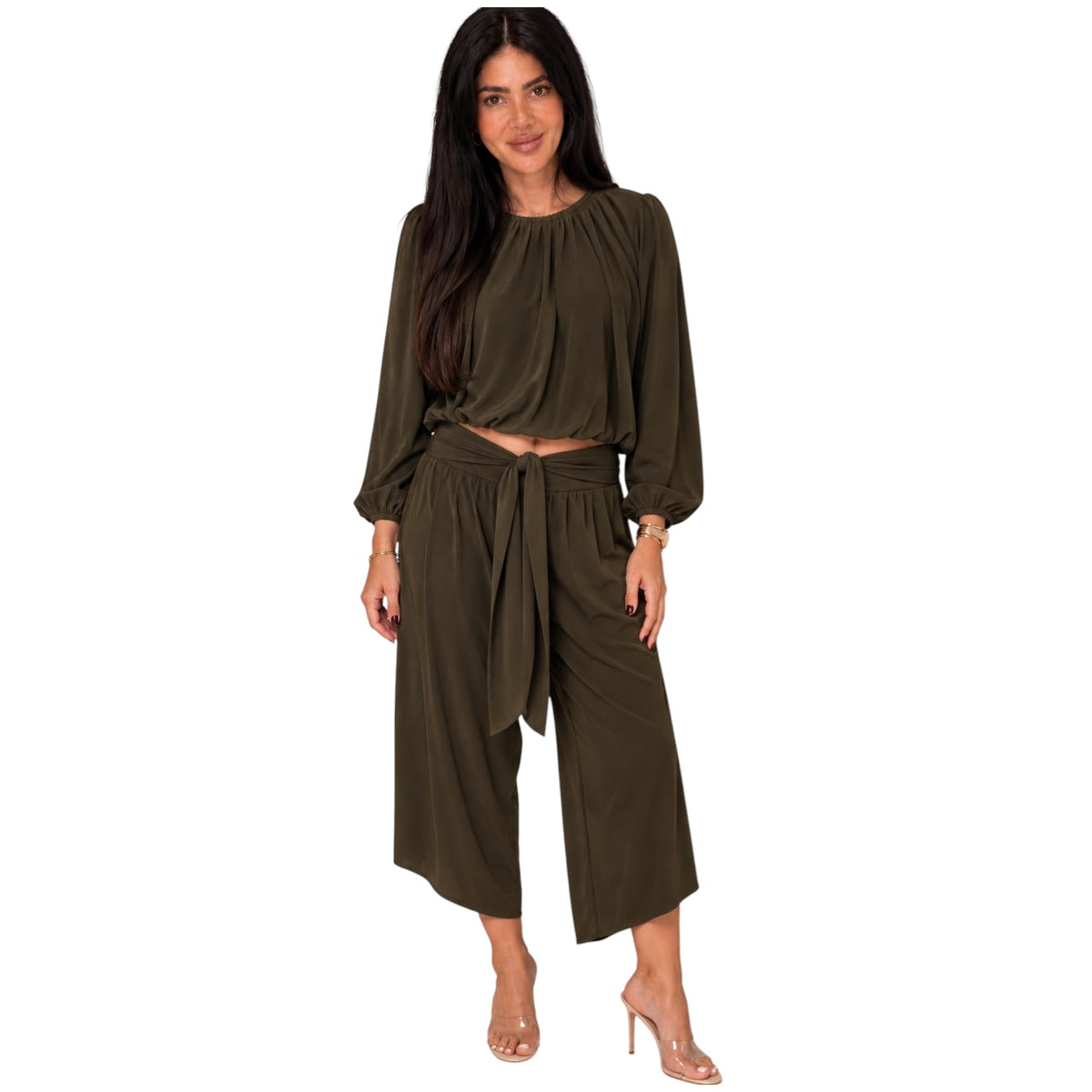 A woman modeling a matching two-piece outfit consisting of a long-sleeve cropped top and high-waisted wide-leg pants in olive green, set against a plain white background.