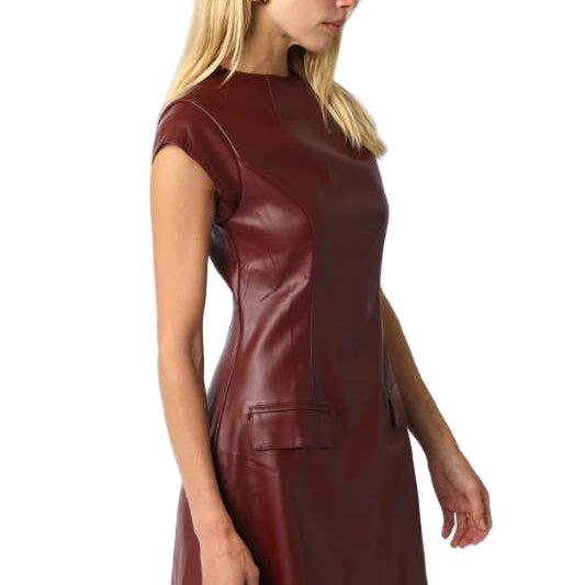 Woman wearing a maroon leather dress on a white background