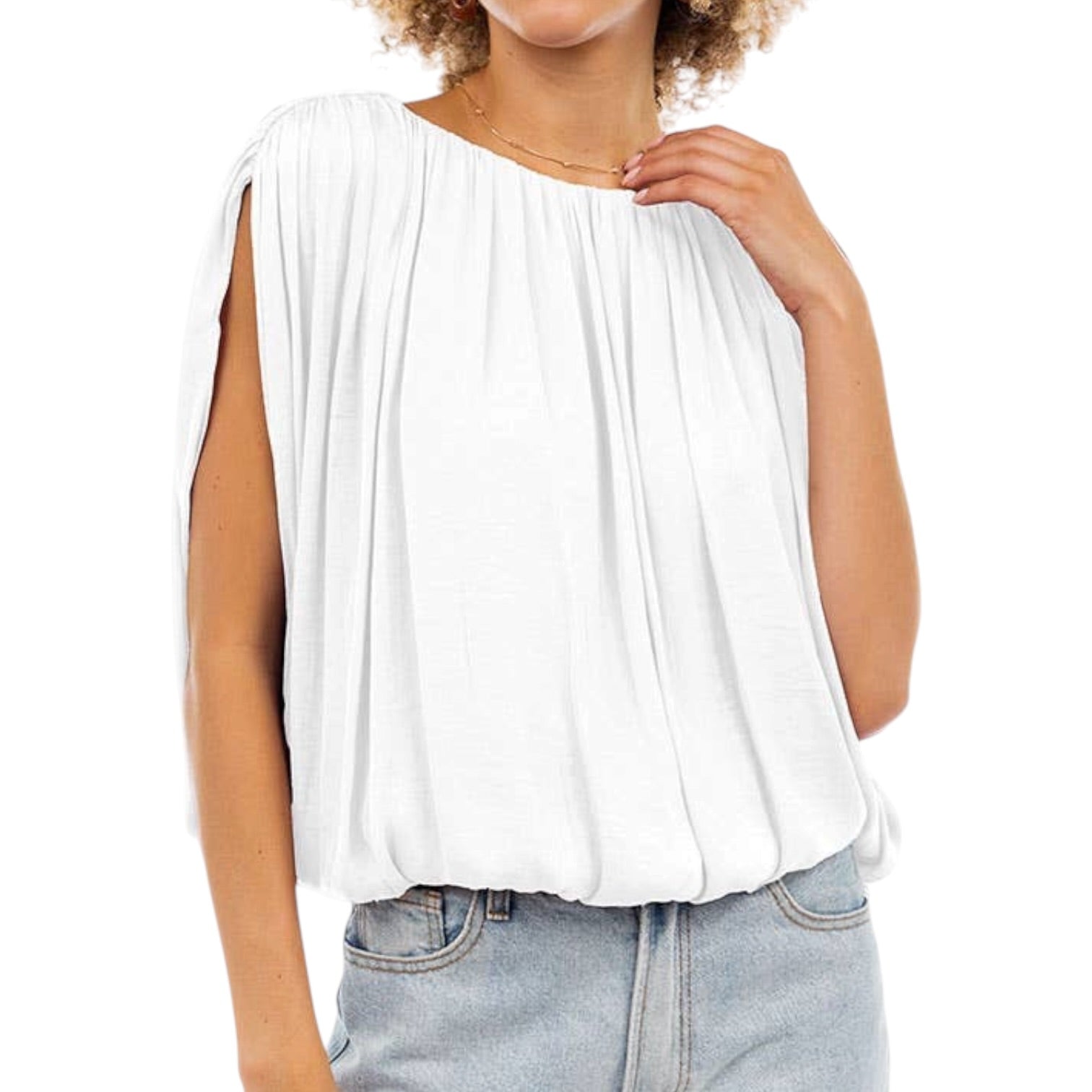 Woman wearing a white sleeveless top and light blue jeans on a white background
