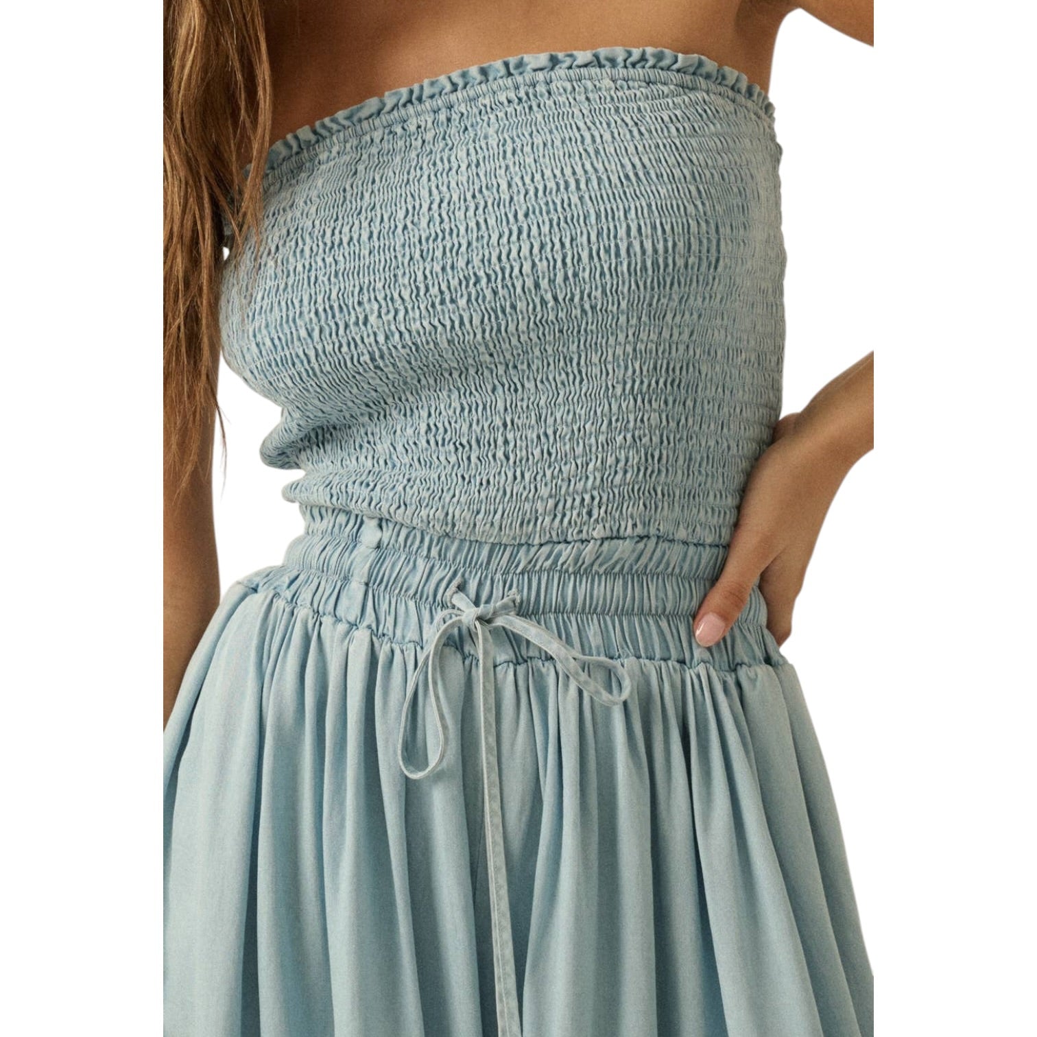 Light blue strapless jumpsuit on a white background