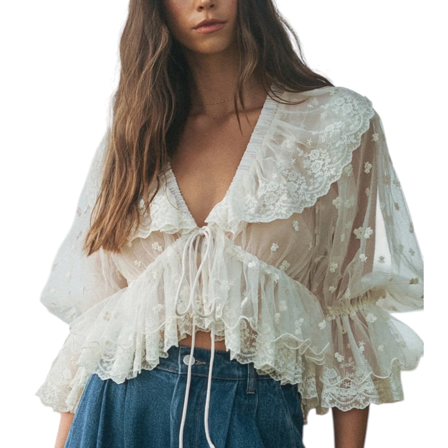 Woman wearing a white lace top with blue jeans on a white background