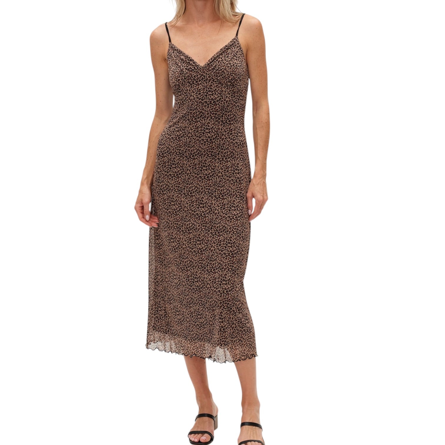 Woman wearing a leopard print slip dress on a white background