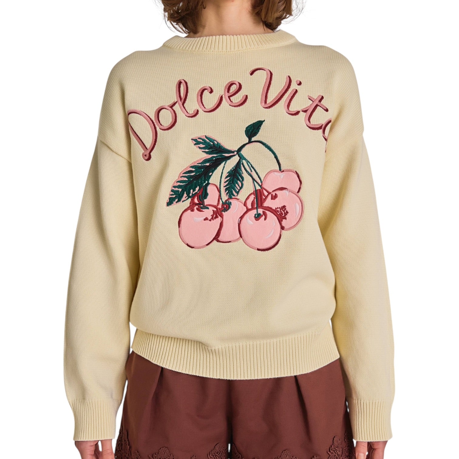Beige sweater with 'Dolce Vita' and cherry design on a white background