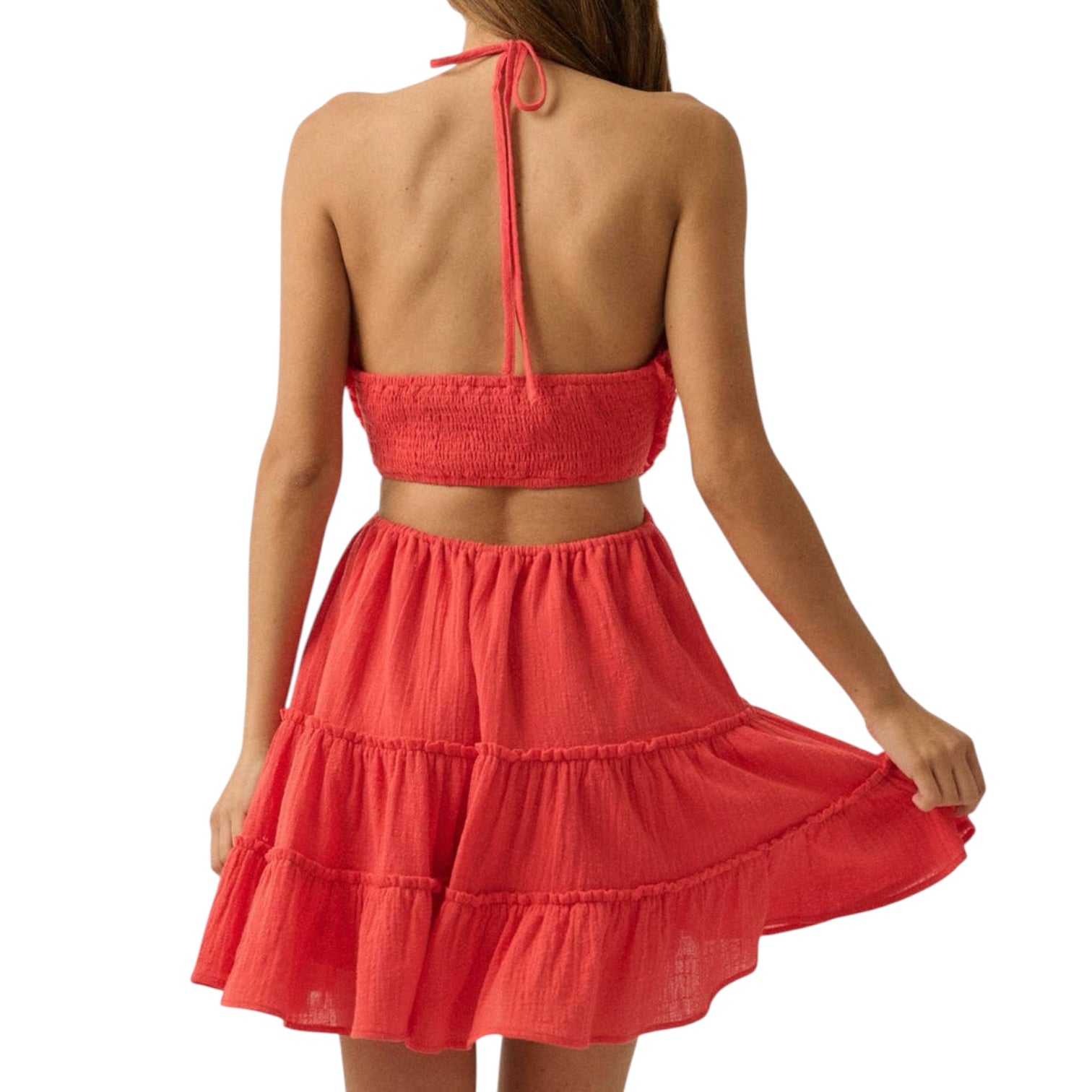 Red romper with a tiered skirt on a white background