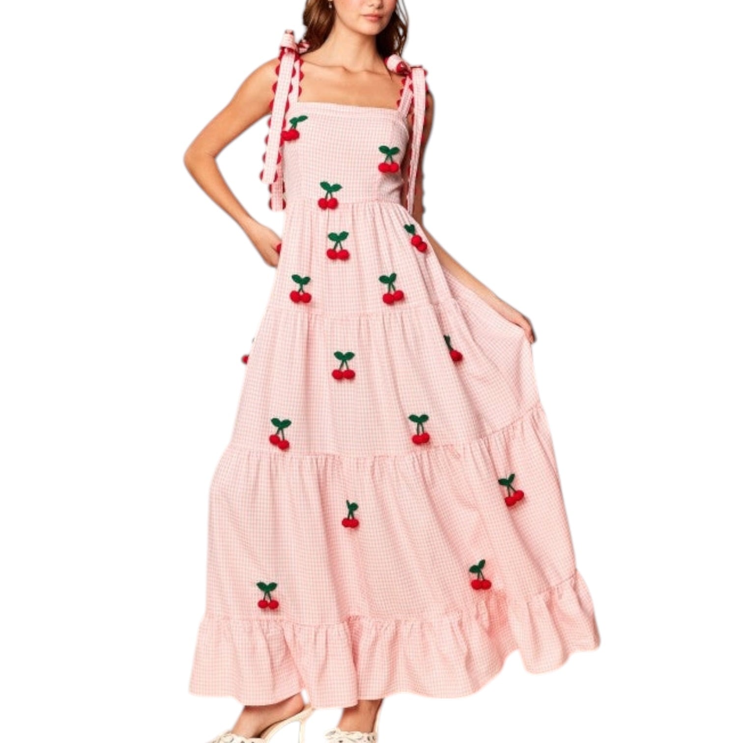 Pink dress with cherry embellishments on a white background