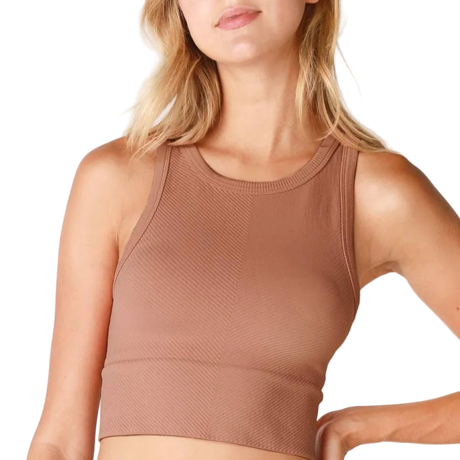 Brown sleeveless top worn by a person on a white background