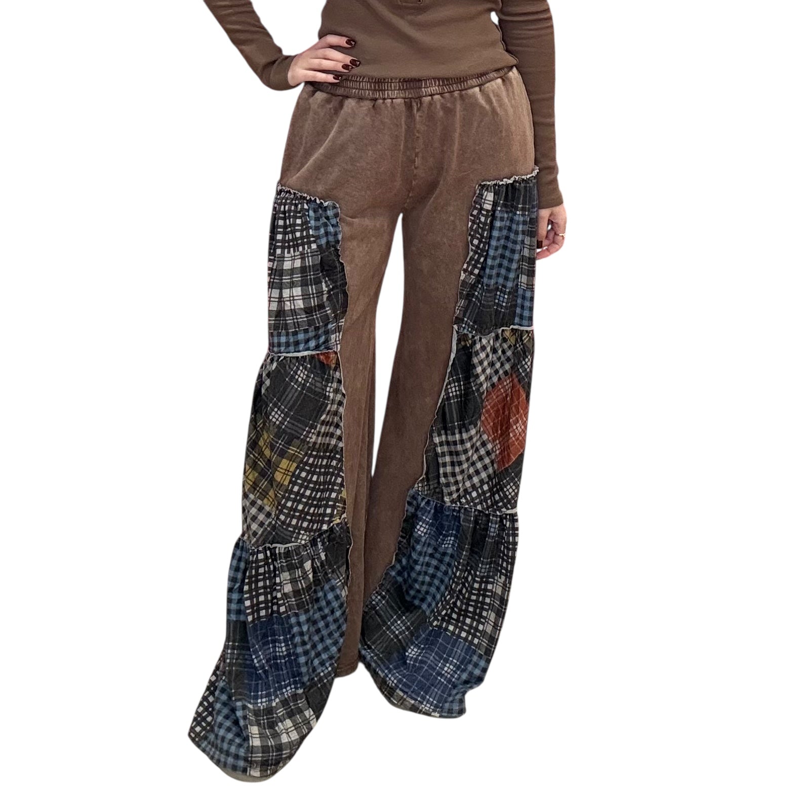 Brown pants with plaid patchwork design on a white background