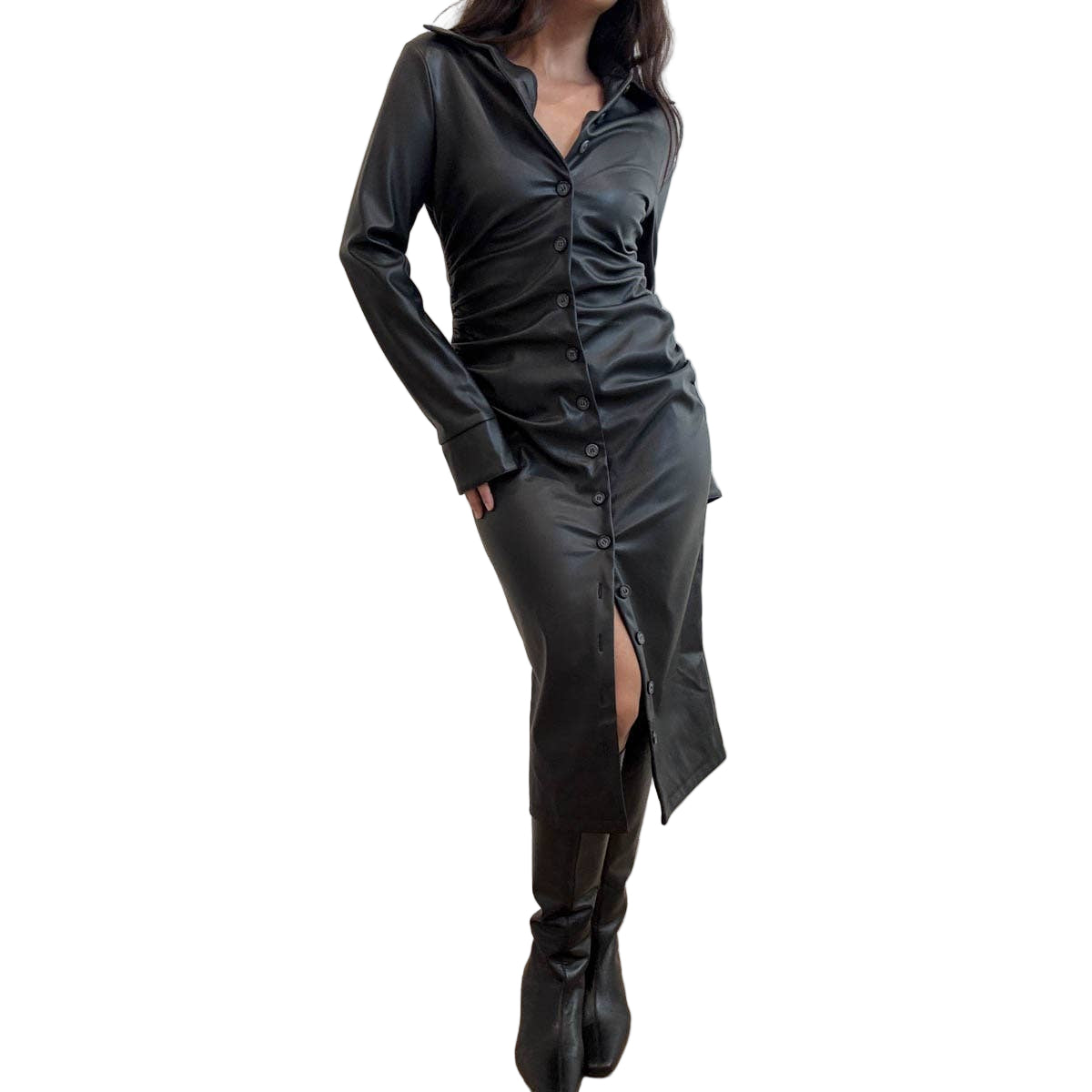 Person wearing a black leather dress with a high slit and black boots against a plain background