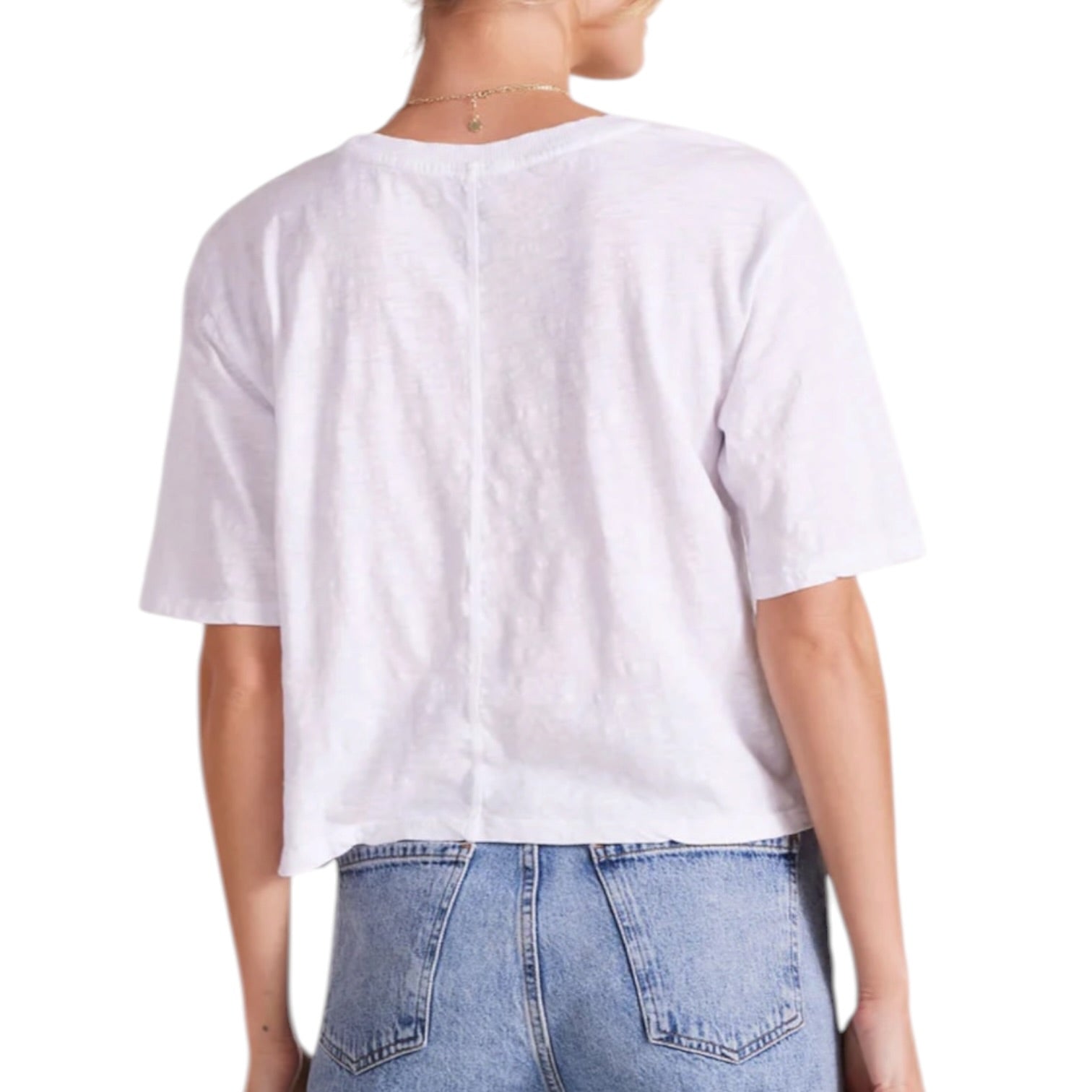 Person wearing a white t-shirt and blue jeans on a white background