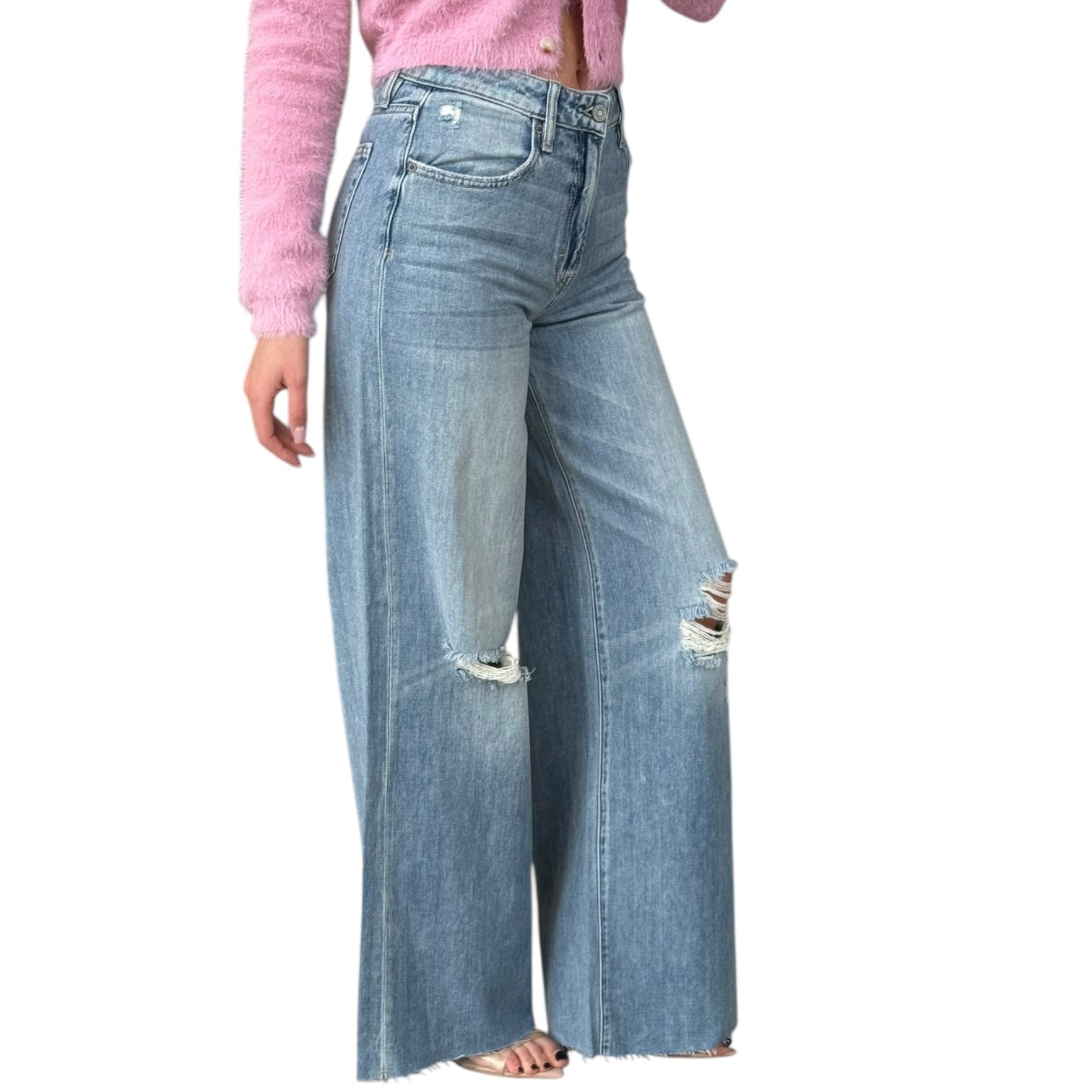Wide-leg jeans with a pink top on a white background