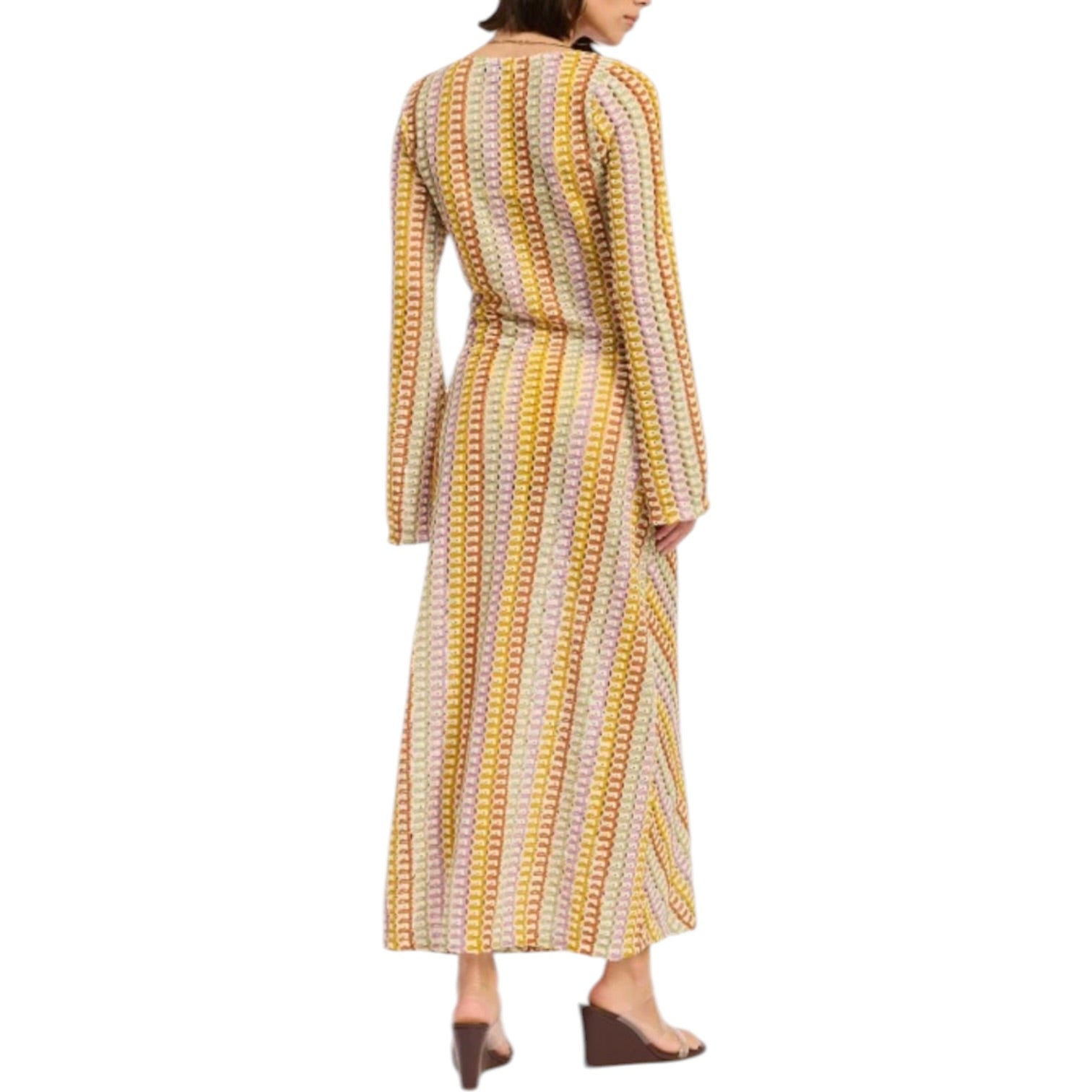 Woman wearing a long, patterned dress on a white background