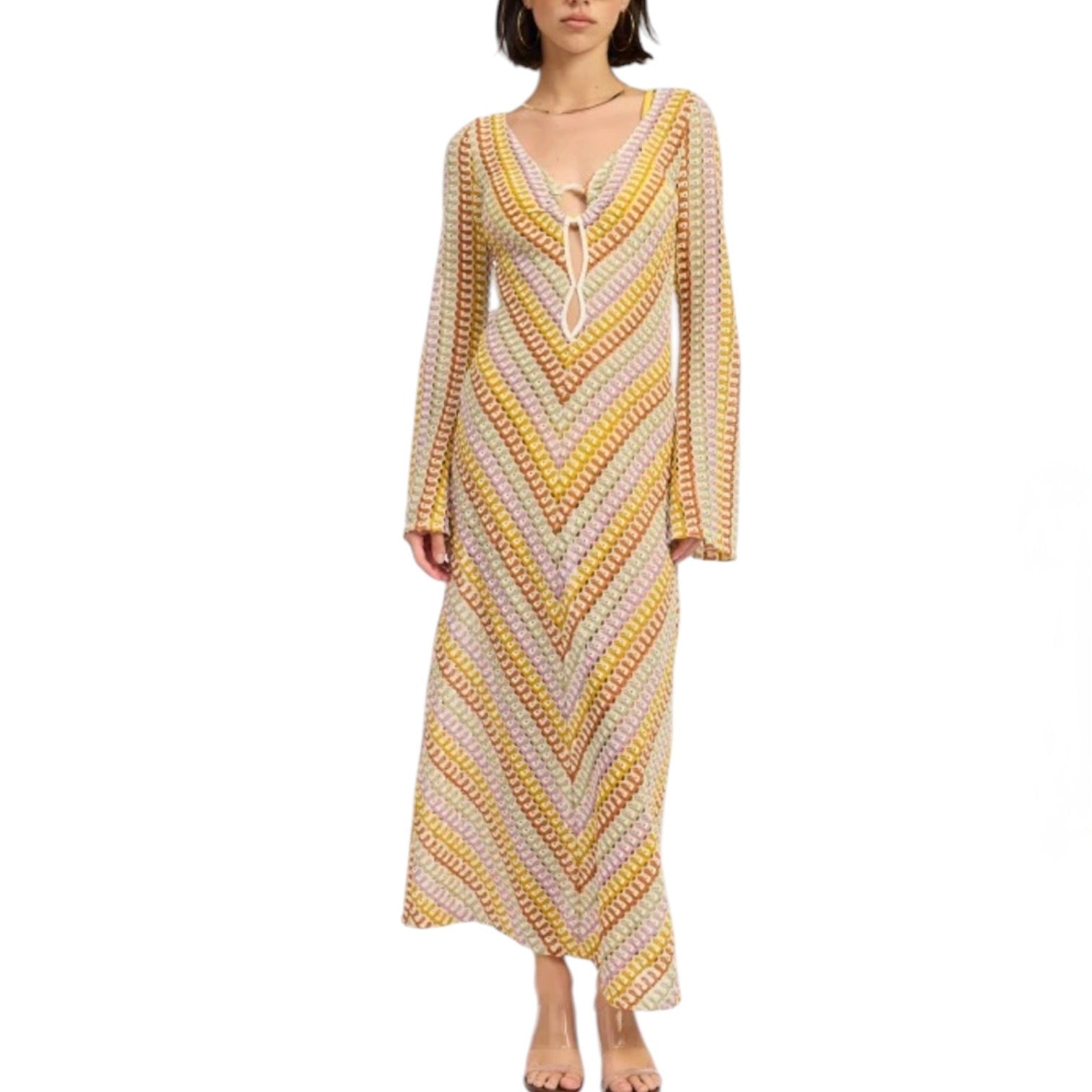 Woman wearing a long, patterned dress on a white background